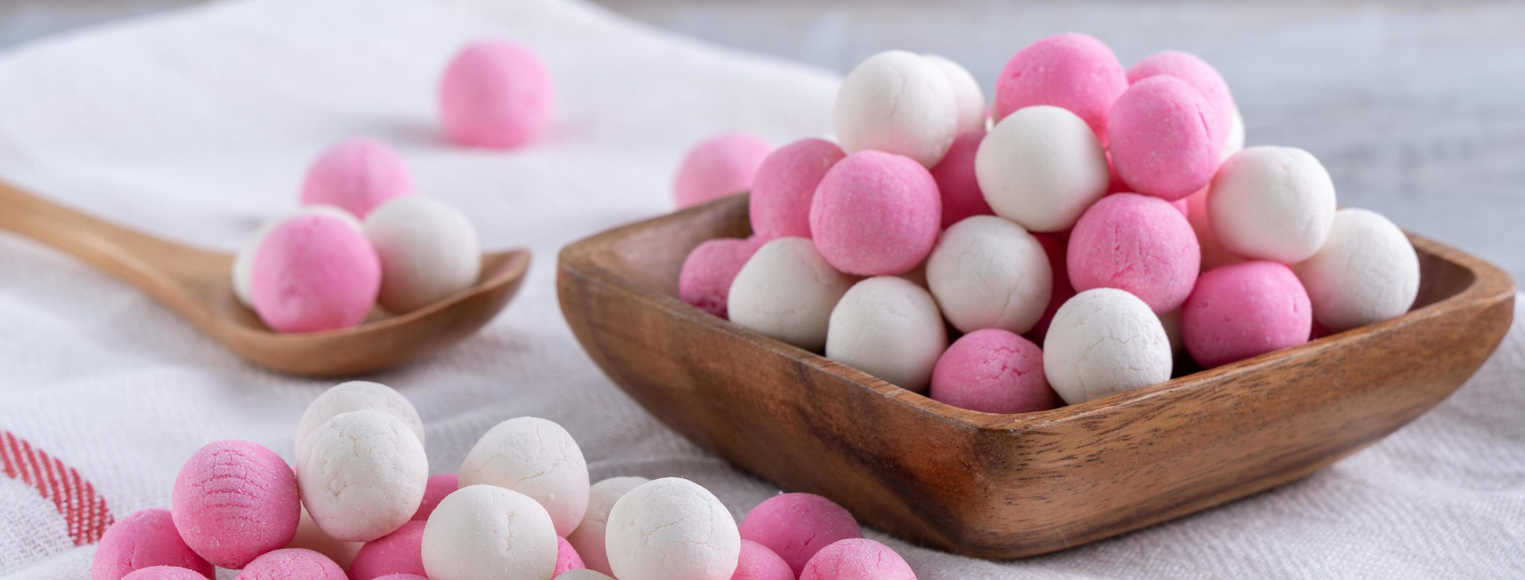 Raw red and white tangyuan on wooden table background for Winter solstice food. Stock Free