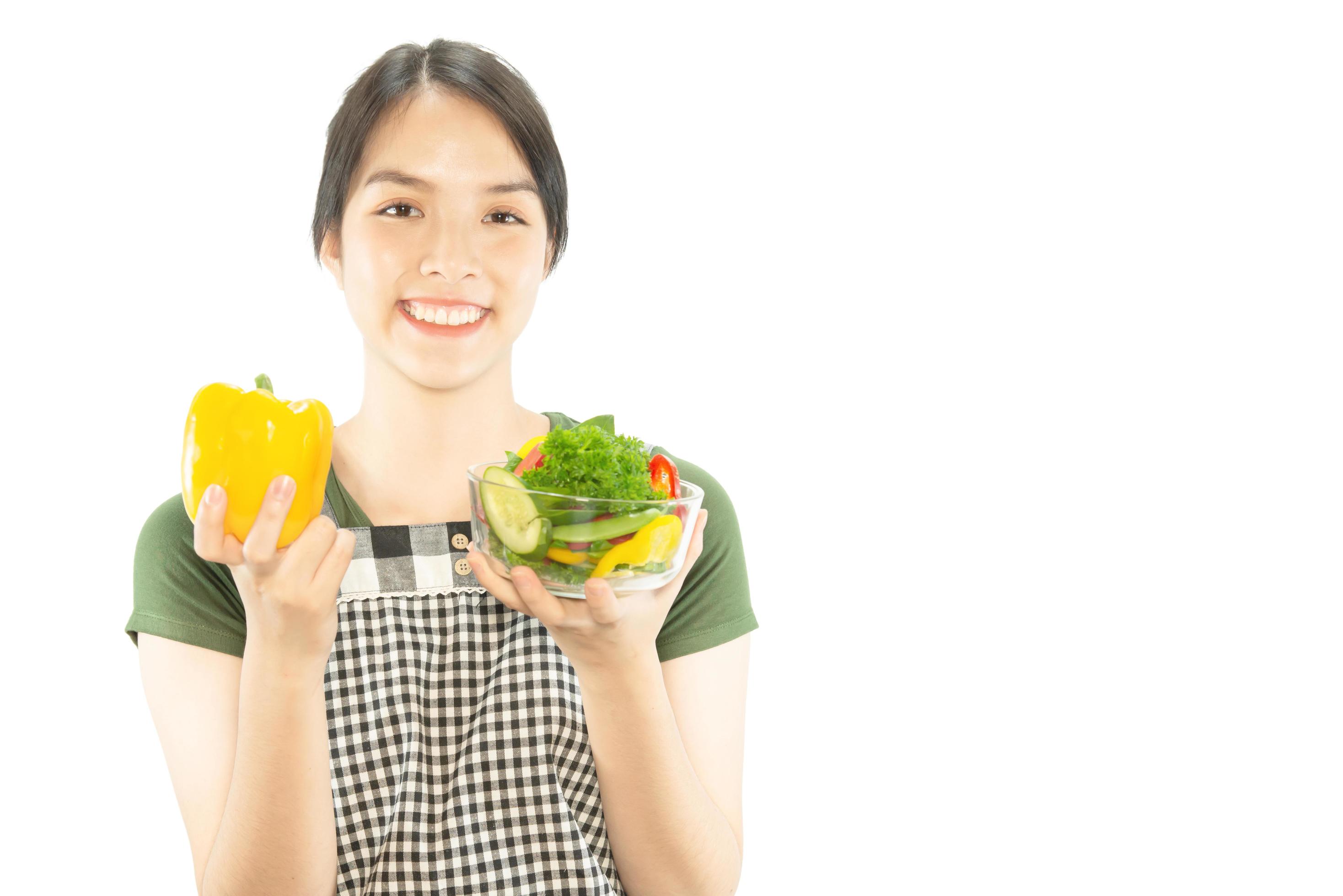 Happy lady holding kichen stuff over copy space background – people home made food preparation concept Stock Free