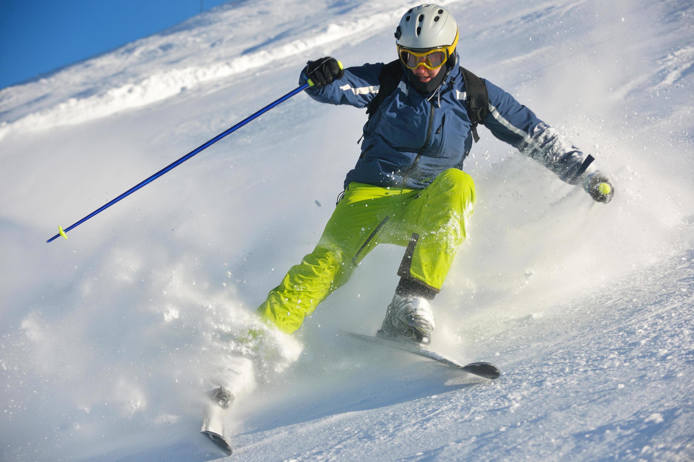 skiing on fresh snow at winter season at beautiful sunny day Stock Free