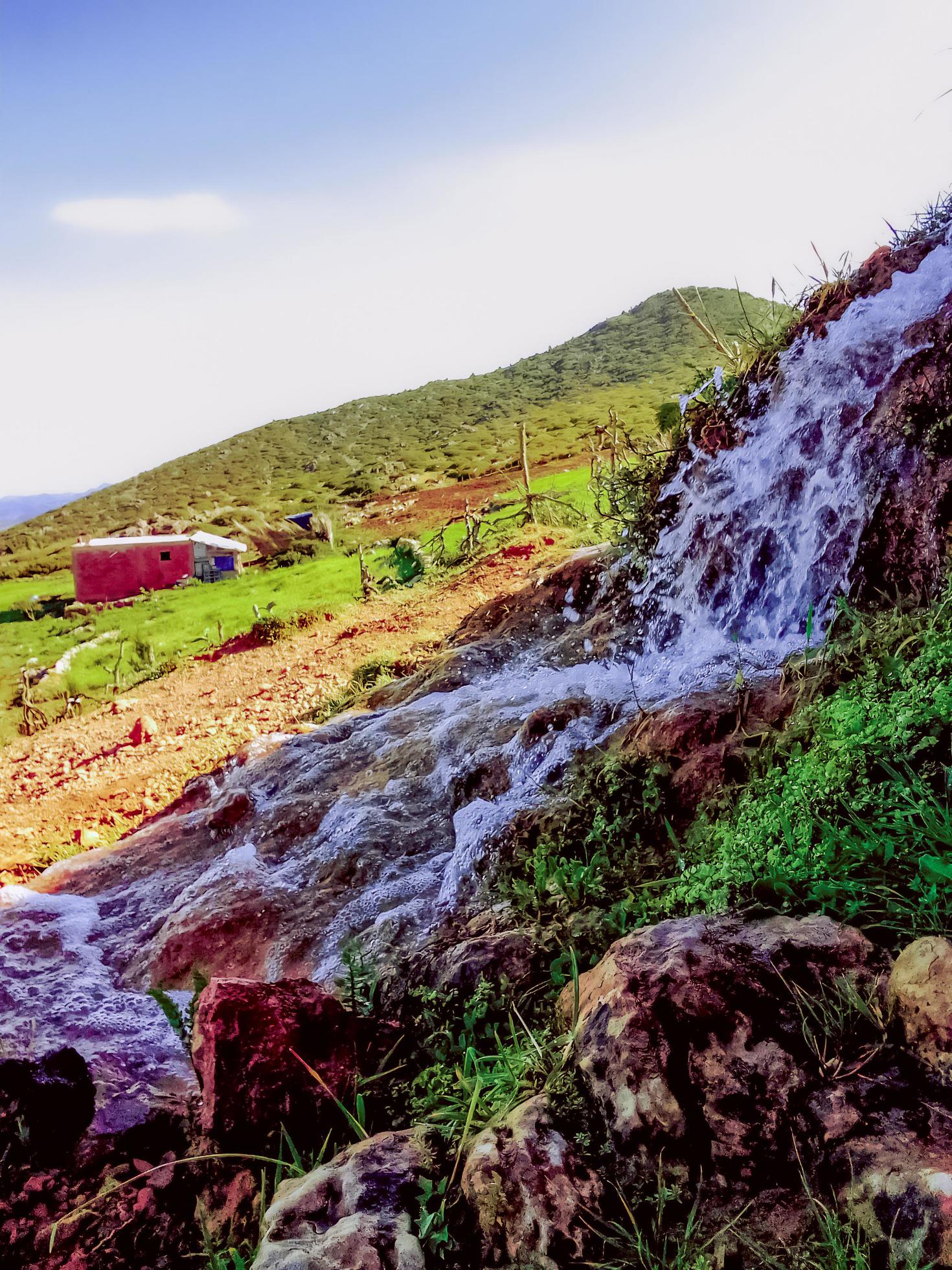 Discover the serene beauty of a water spring near a country house a journey into the heart of rural tranquility and natural splendor Stock Free