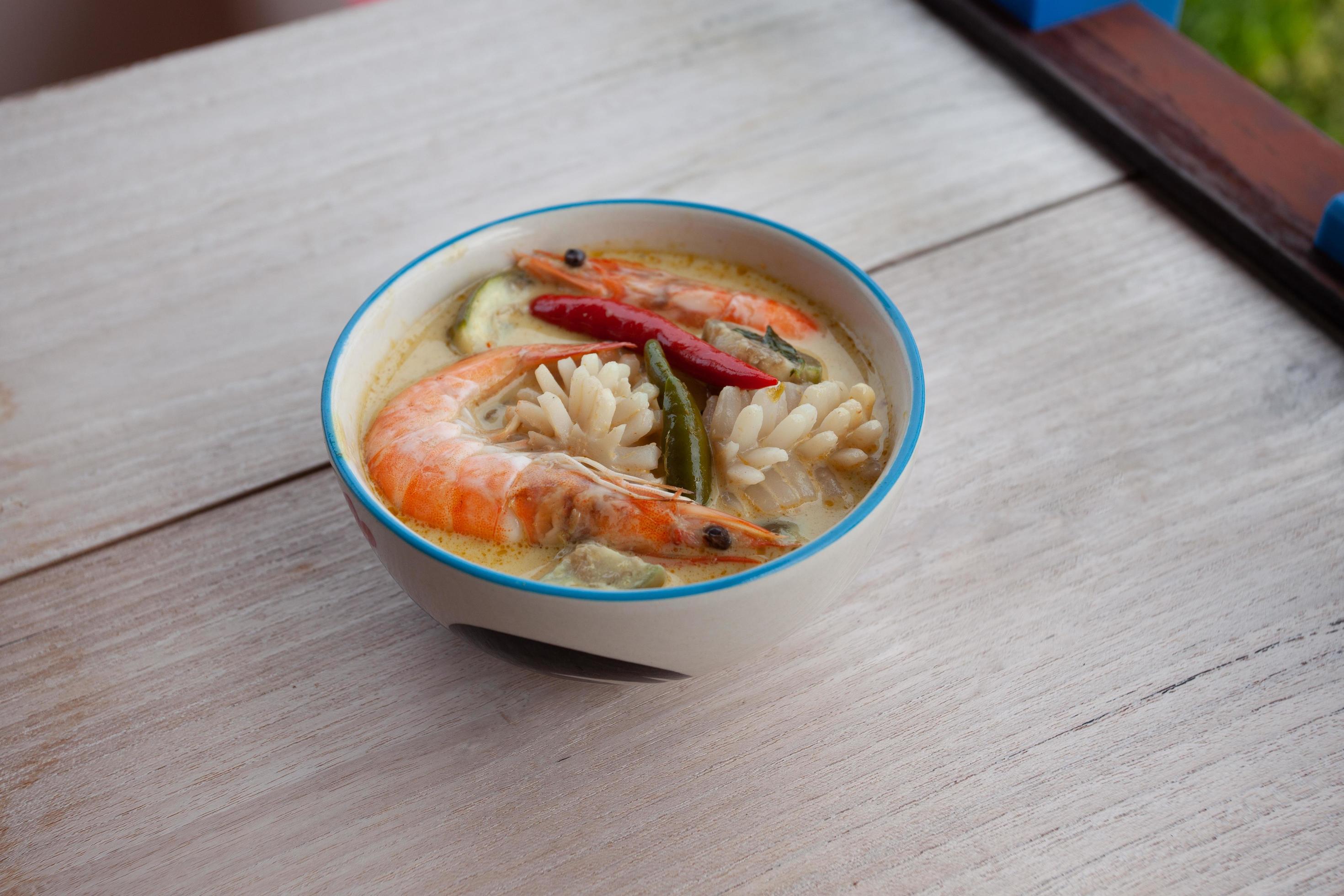 Thai food Pork green curry on wooden floor Stock Free