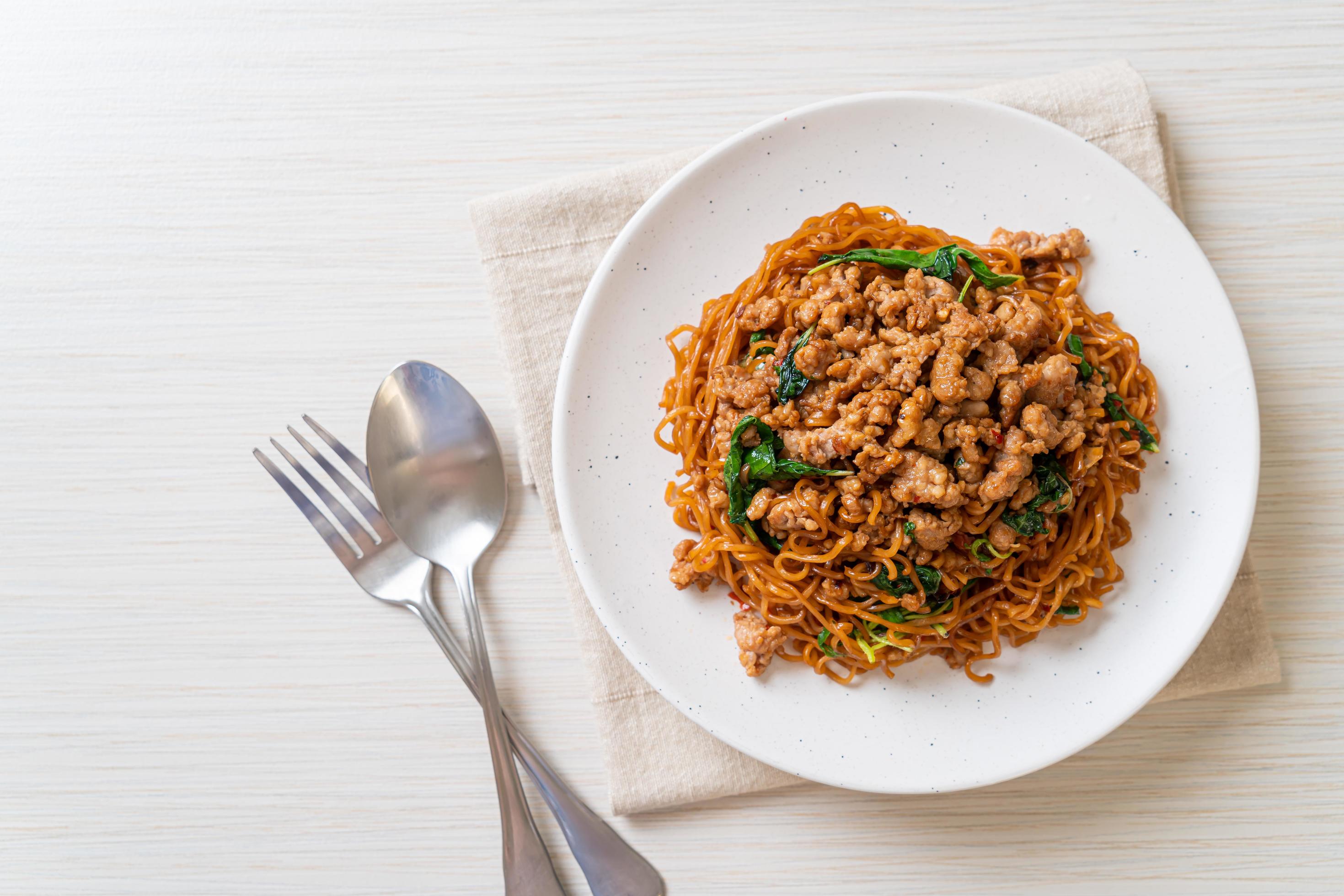 Stir-fried instant noodles with Thai basil and minced pork – Asian food style Stock Free