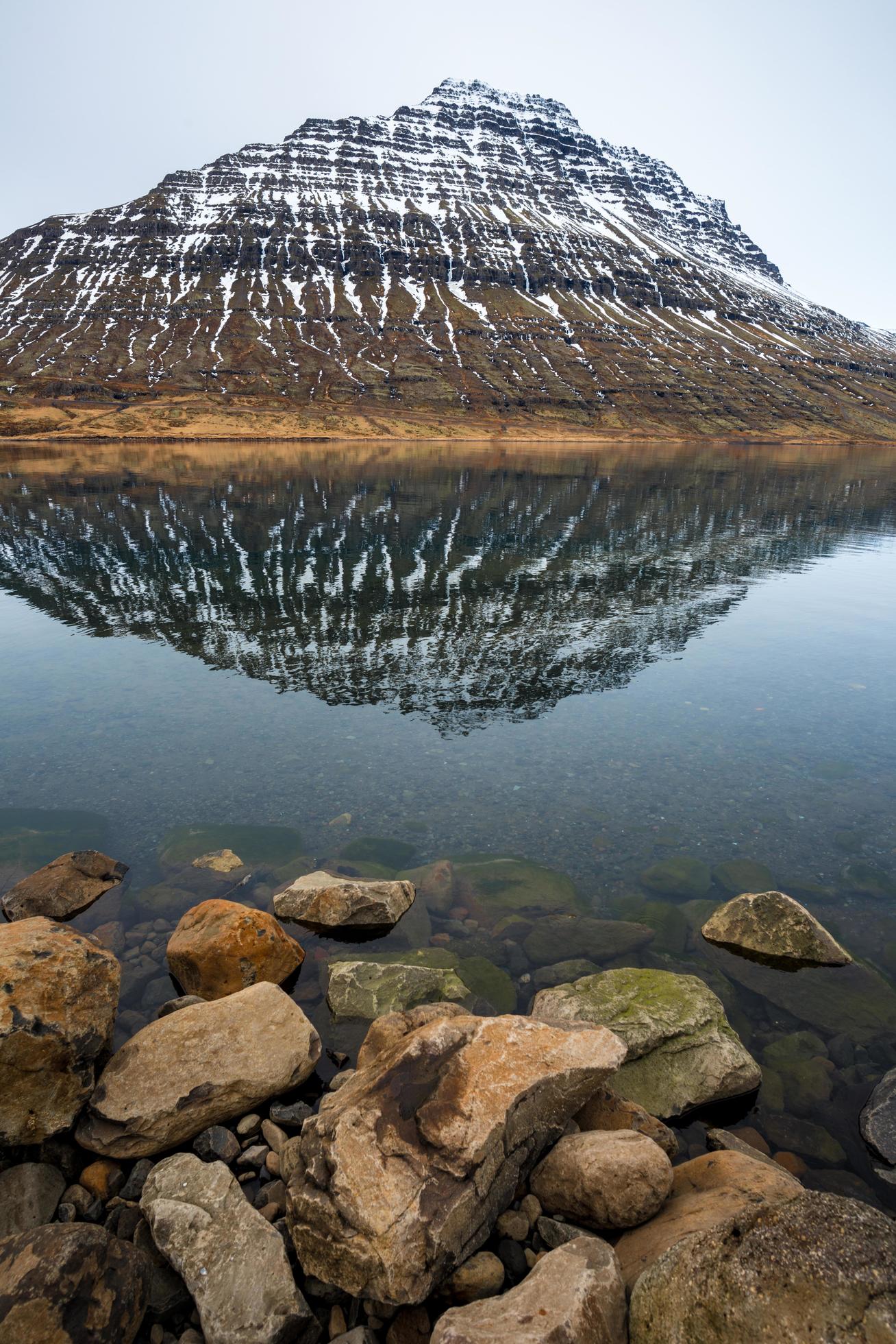 Holmatindur the mighty mountain of Eskifjordur town in East fjord of East Iceland. Stock Free