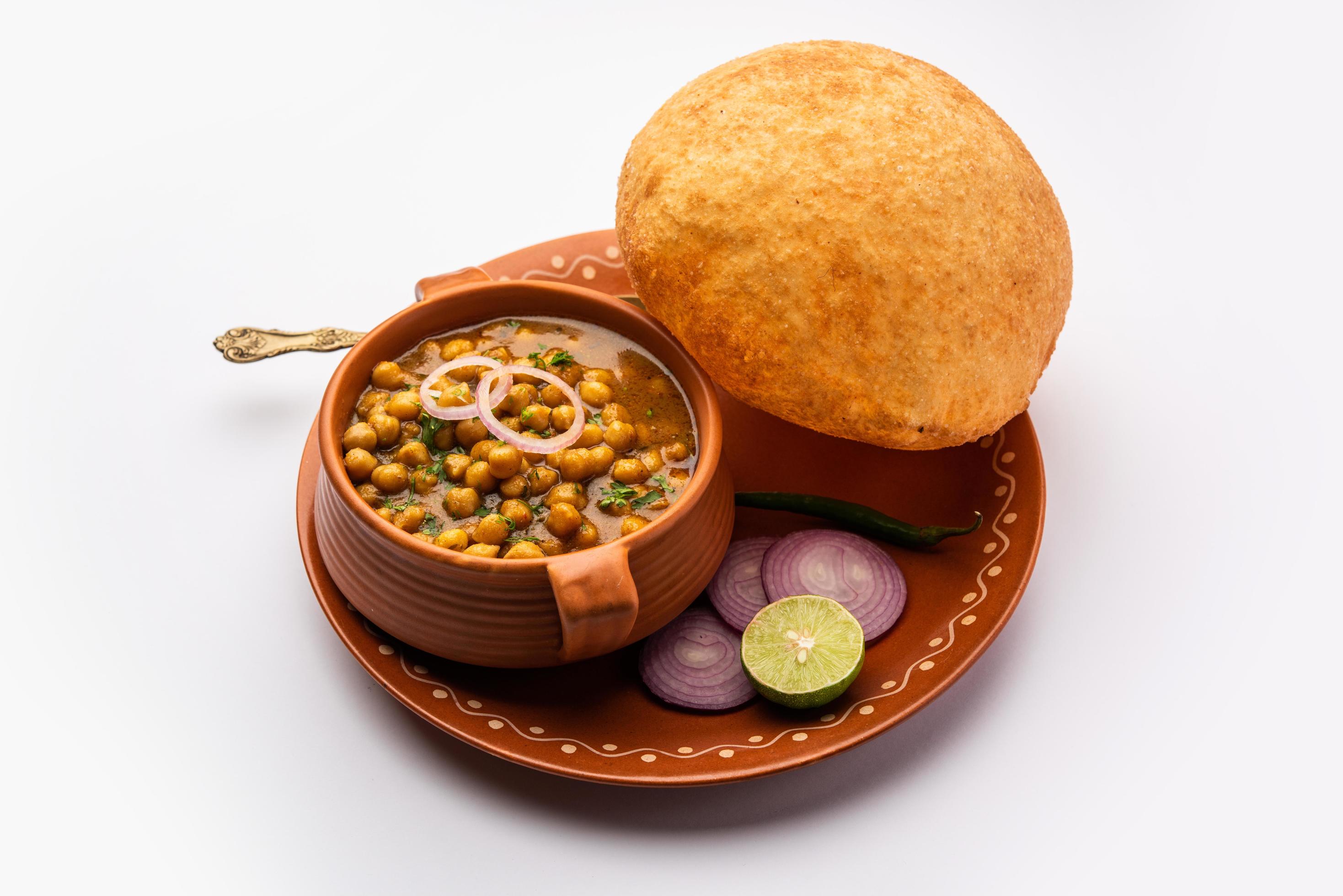 Chole bhature is a North Indian food dish. A combination of chana masala and bhatura or puri Stock Free