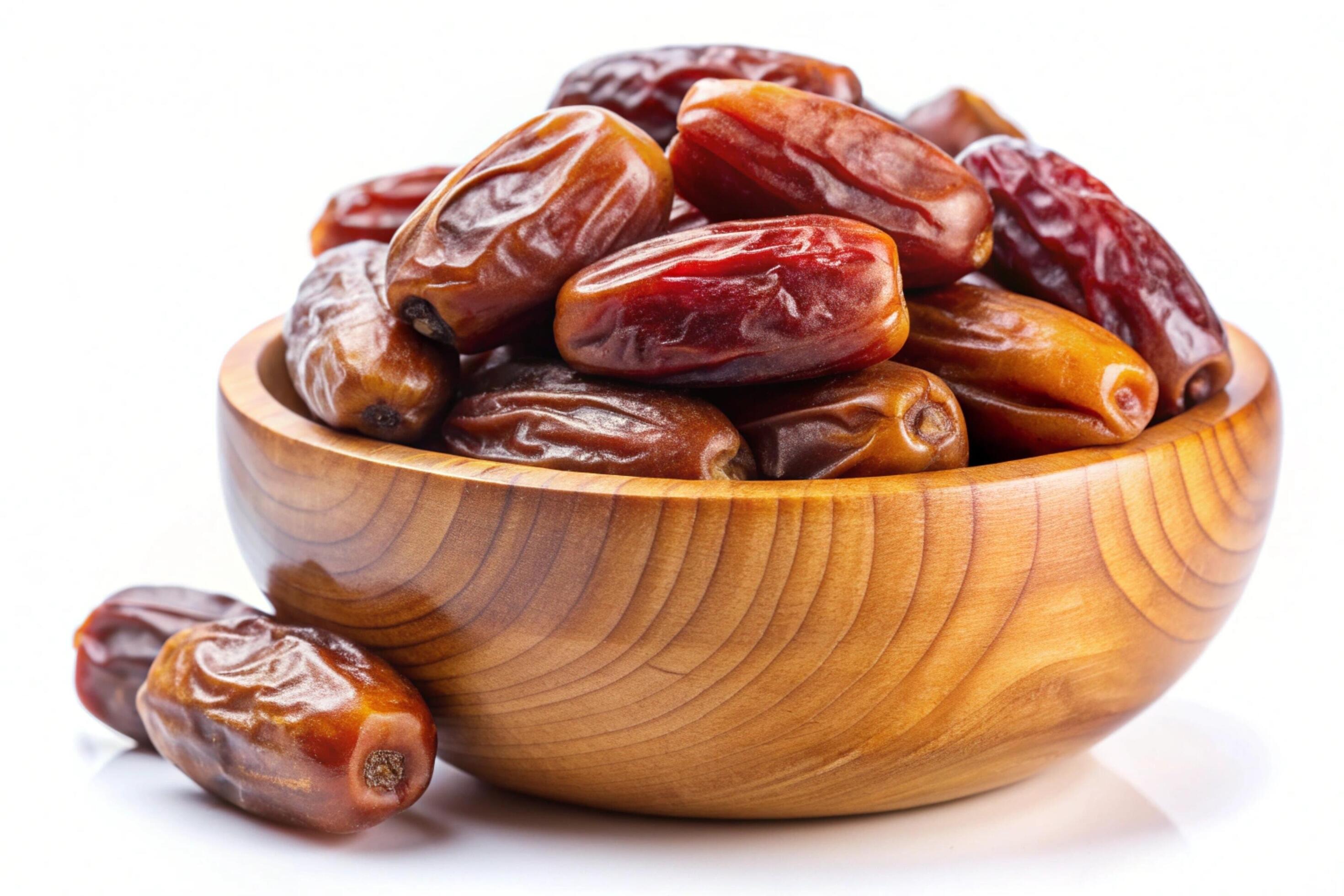 Dates in wood bowl isolated on white background Stock Free