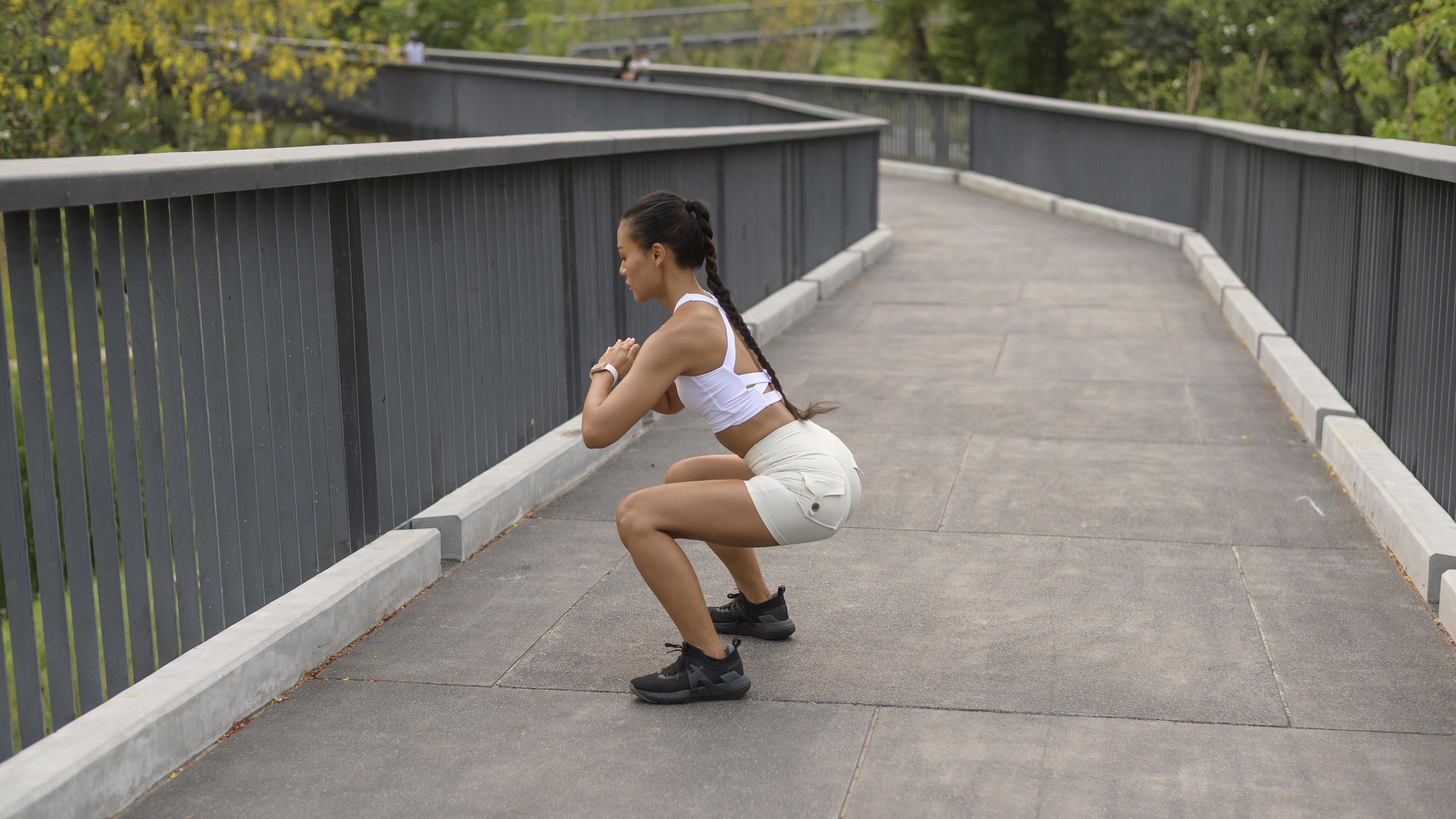 A young fitness woman in sportswear exercising in city park, Healthy and Lifestyles. Stock Free