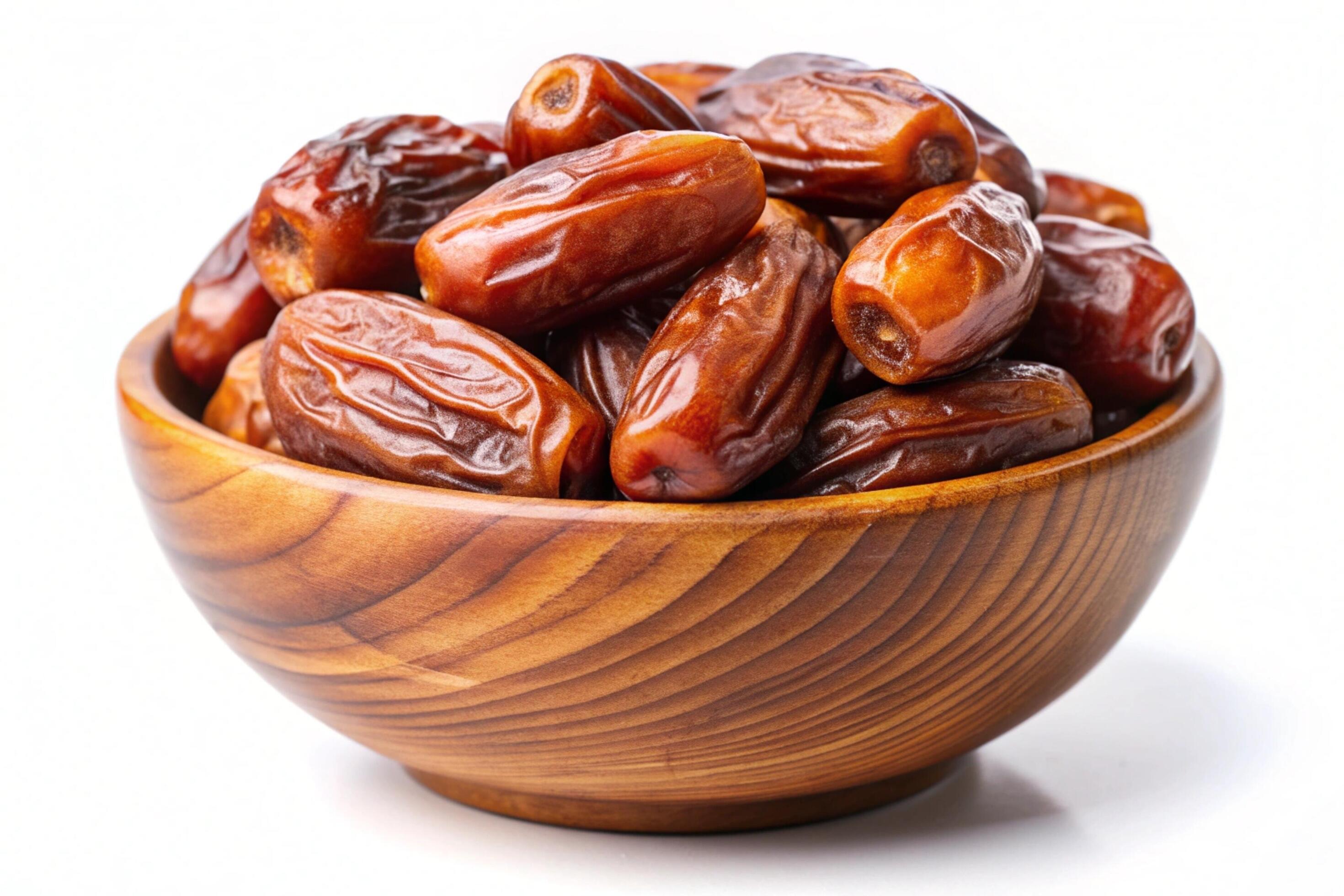 Dates in wood bowl isolated on white background Stock Free