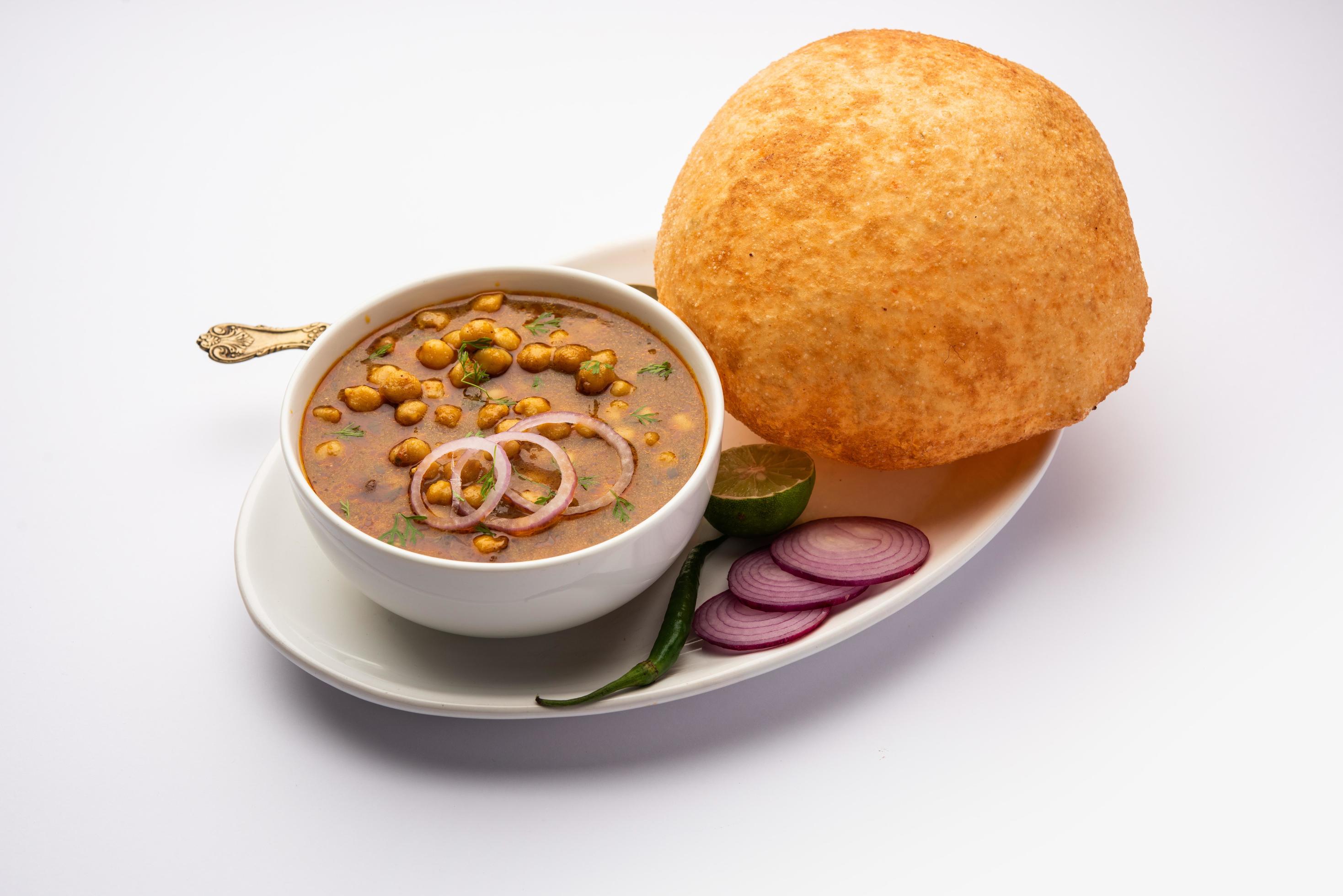 Chole bhature is a North Indian food dish. A combination of chana masala and bhatura or puri Stock Free