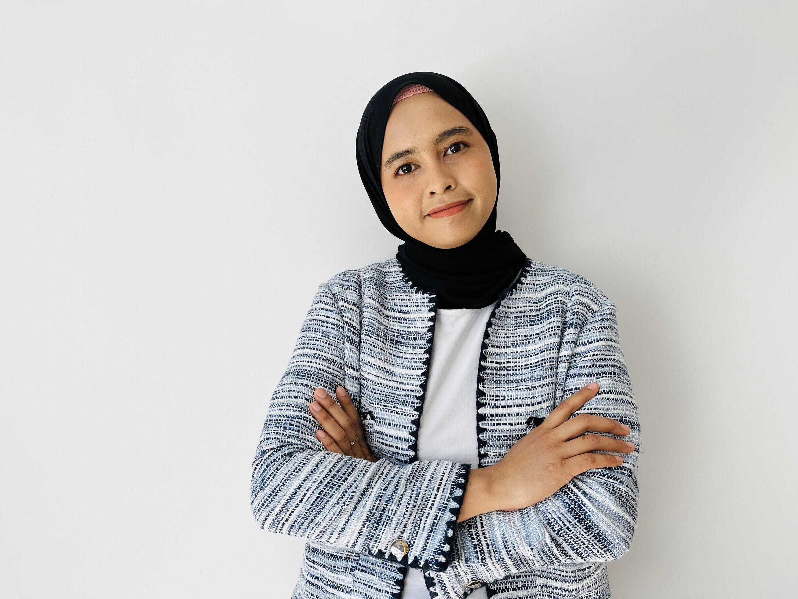 Smiling face young Asian Muslim woman crossed arms and looking confident isolated over white background Stock Free