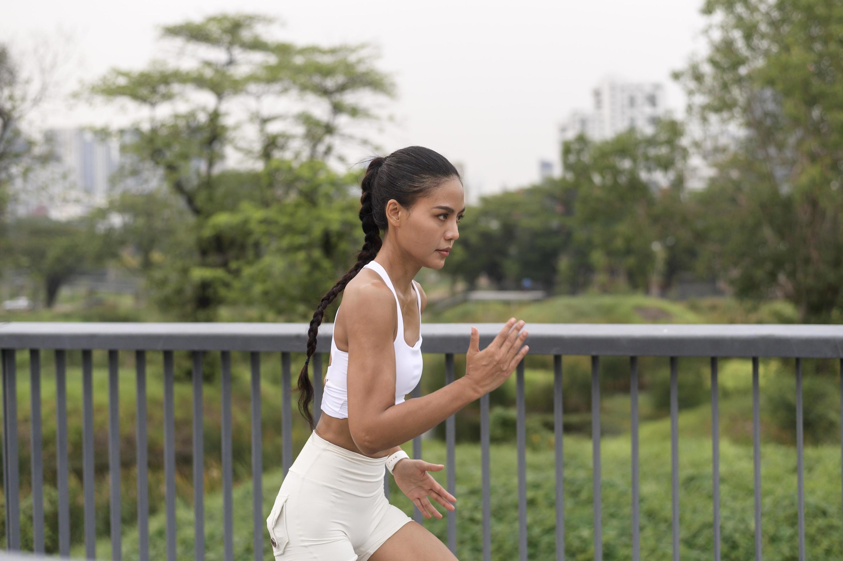 A young fitness woman in sportswear exercising in city park, Healthy and Lifestyles. Stock Free