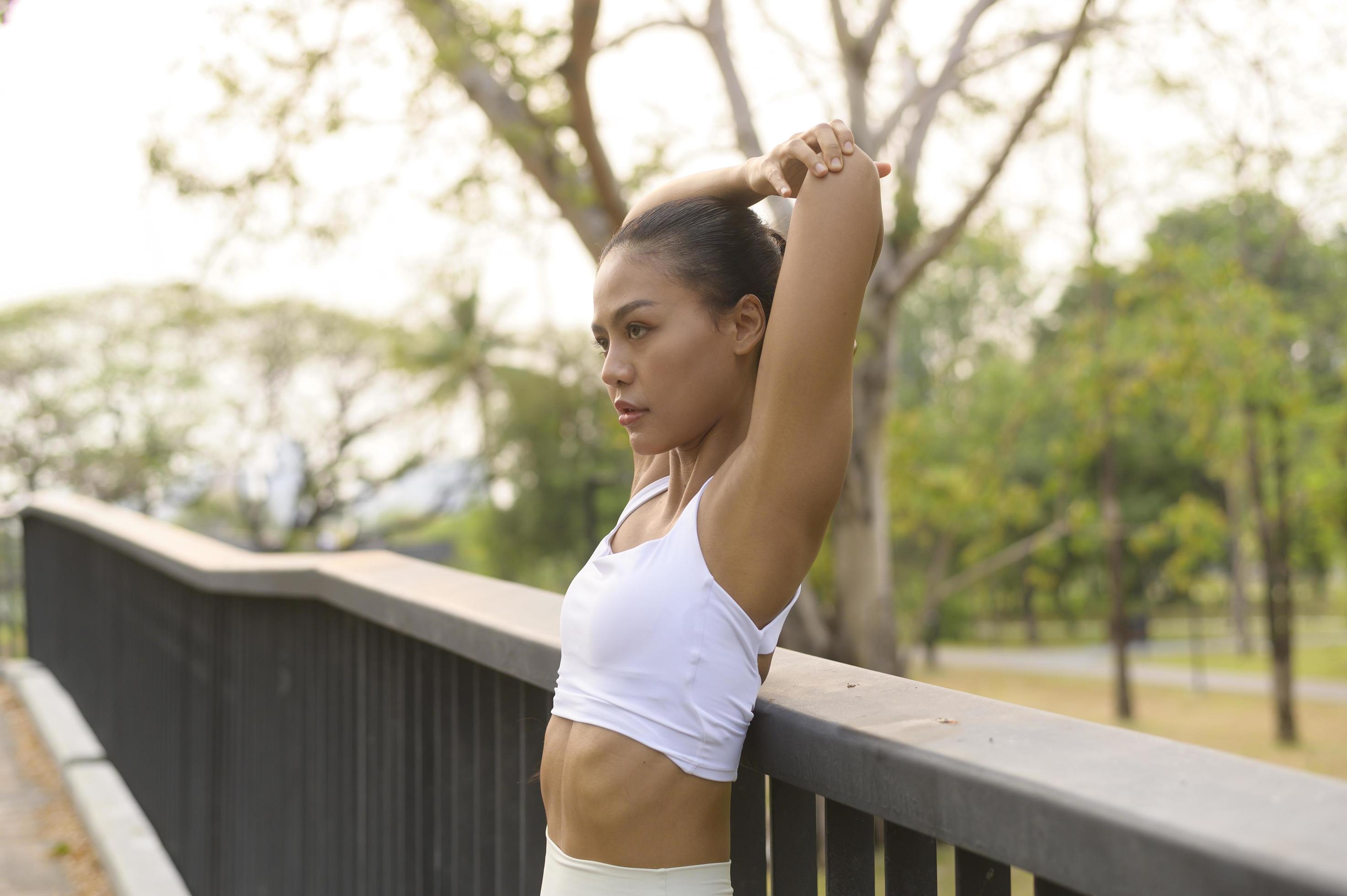 A young fitness woman in sportswear exercising in city park, Healthy and Lifestyles. Stock Free