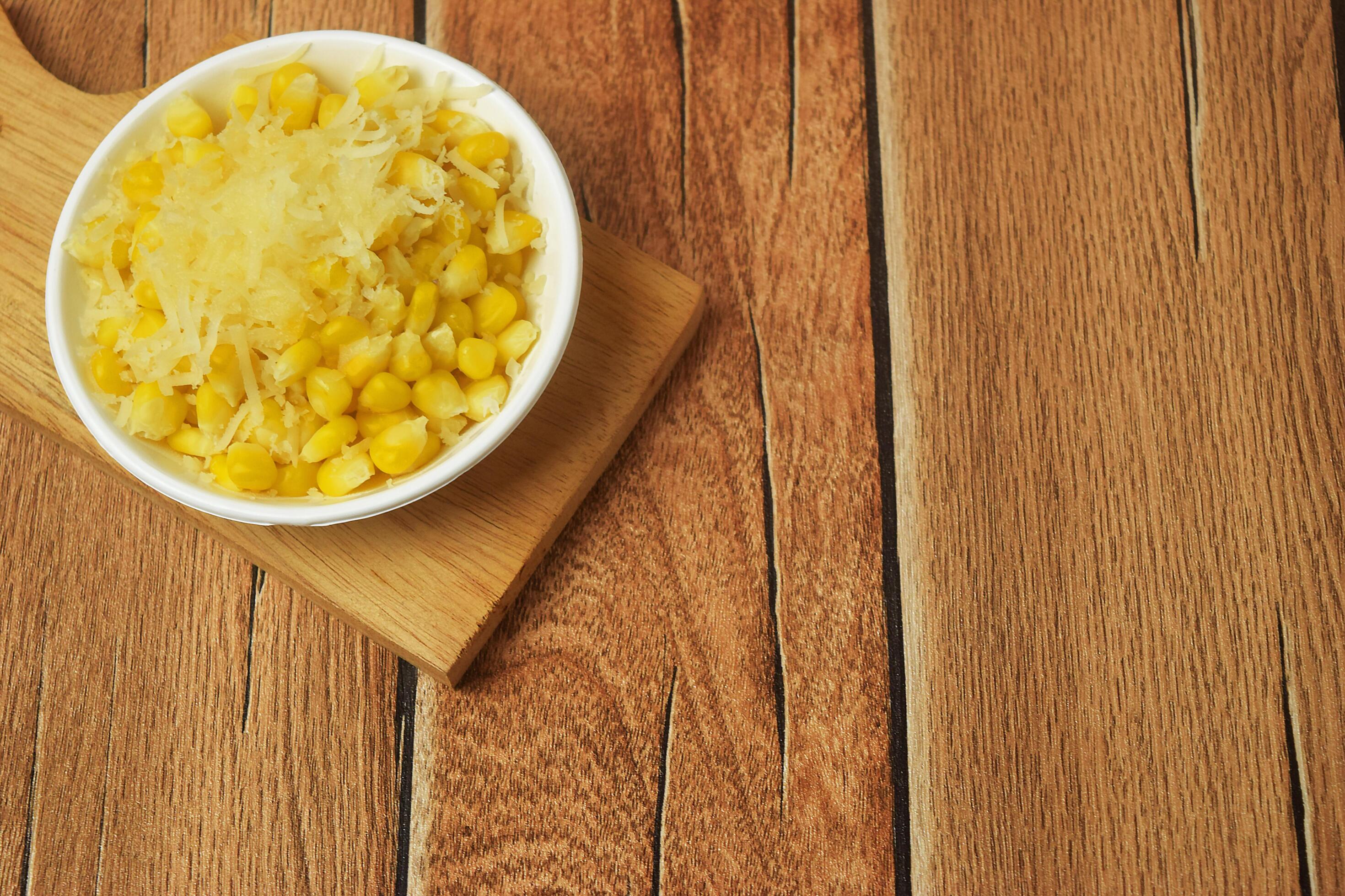 Closeup photo of some shaved corn sprinkled with sweet cheese Stock Free