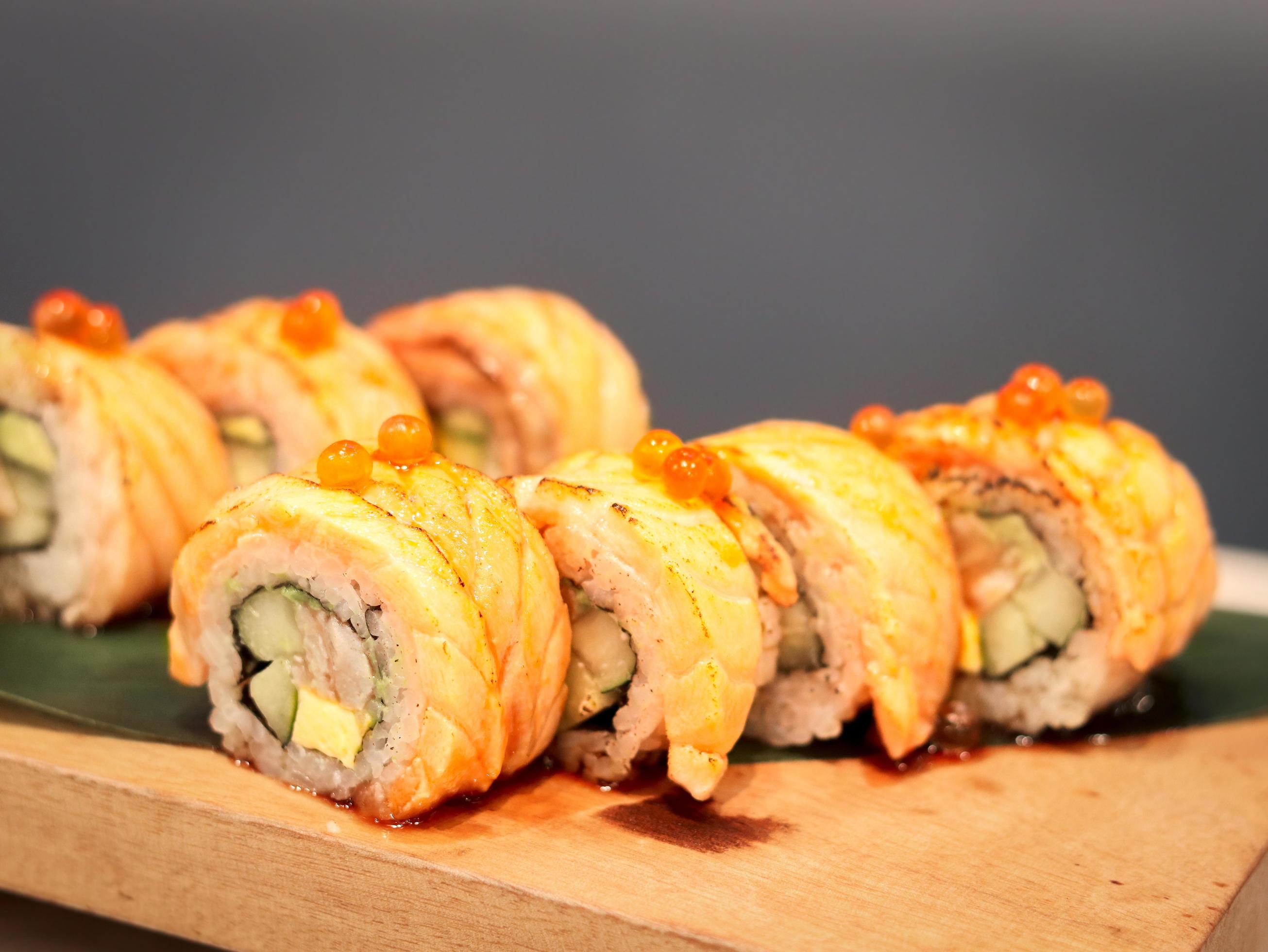 Sushi roll with salmon burned, delicious traditional japanese food Stock Free