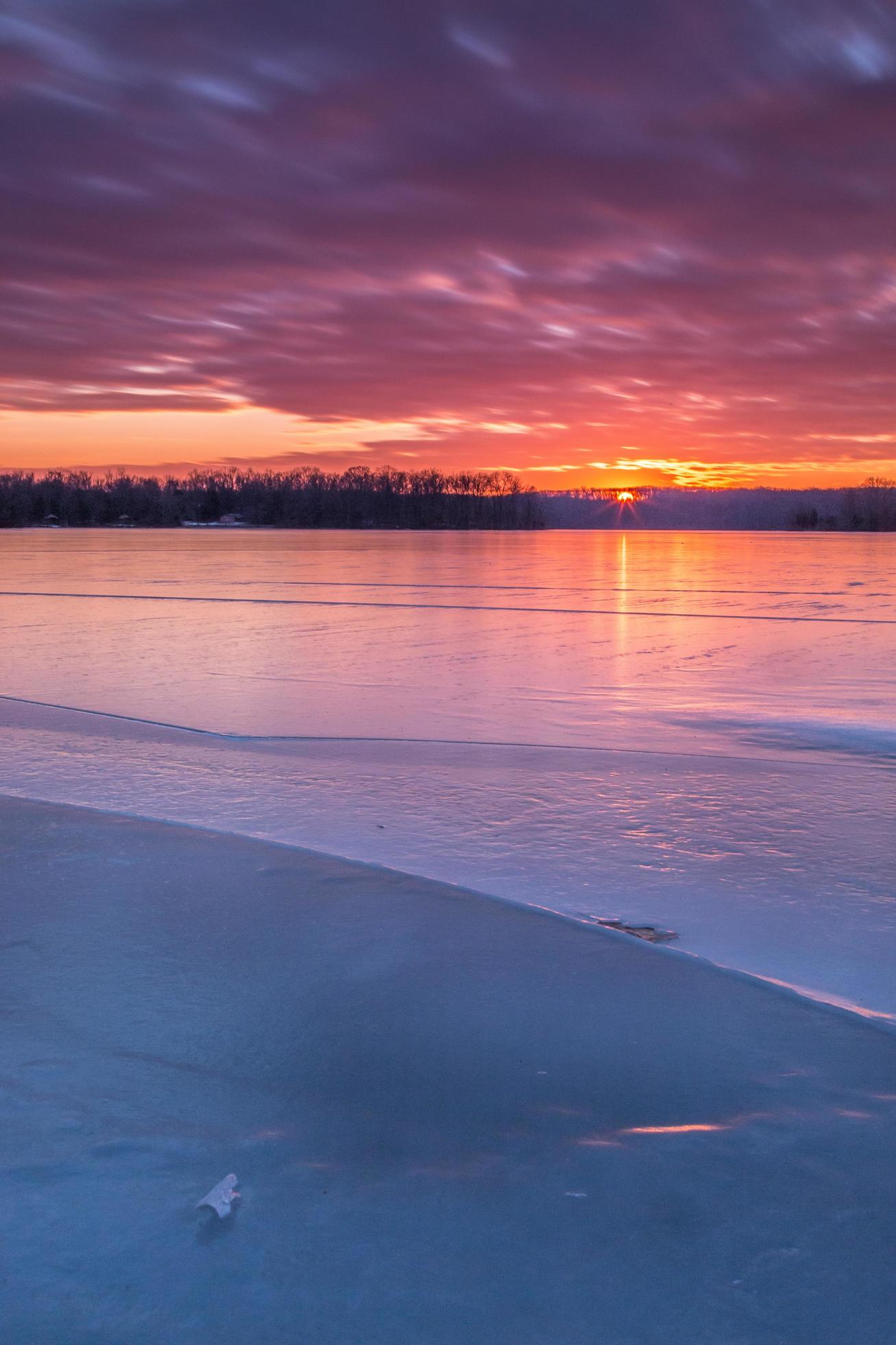 Colorful winter sunset over a frozen lake Stock Free