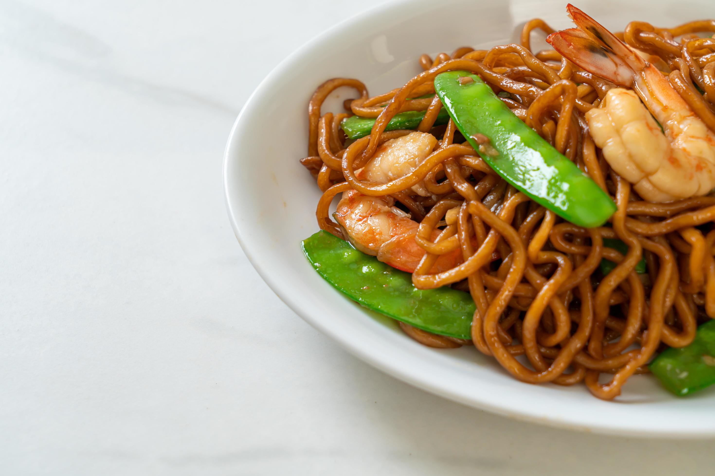 Stir-fried yakisoba noodles with green peas and shrimps – Asian food style Stock Free