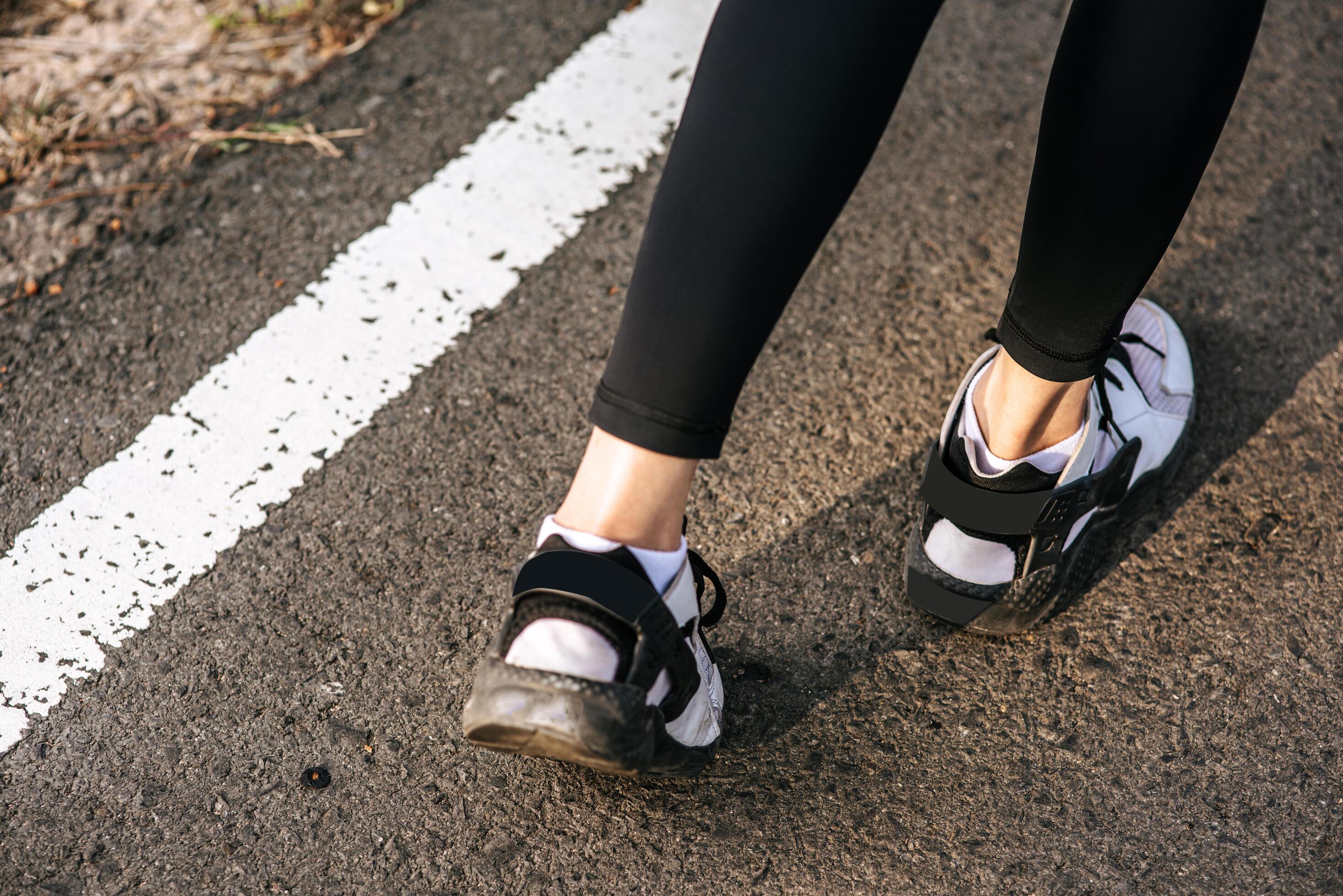 Runner woman feet running on road closeup on shoe. Sports healthy lifestyle concept. Stock Free