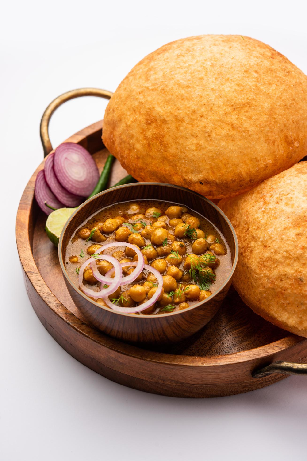 Chole bhature is a North Indian food dish. A combination of chana masala and bhatura or puri Stock Free