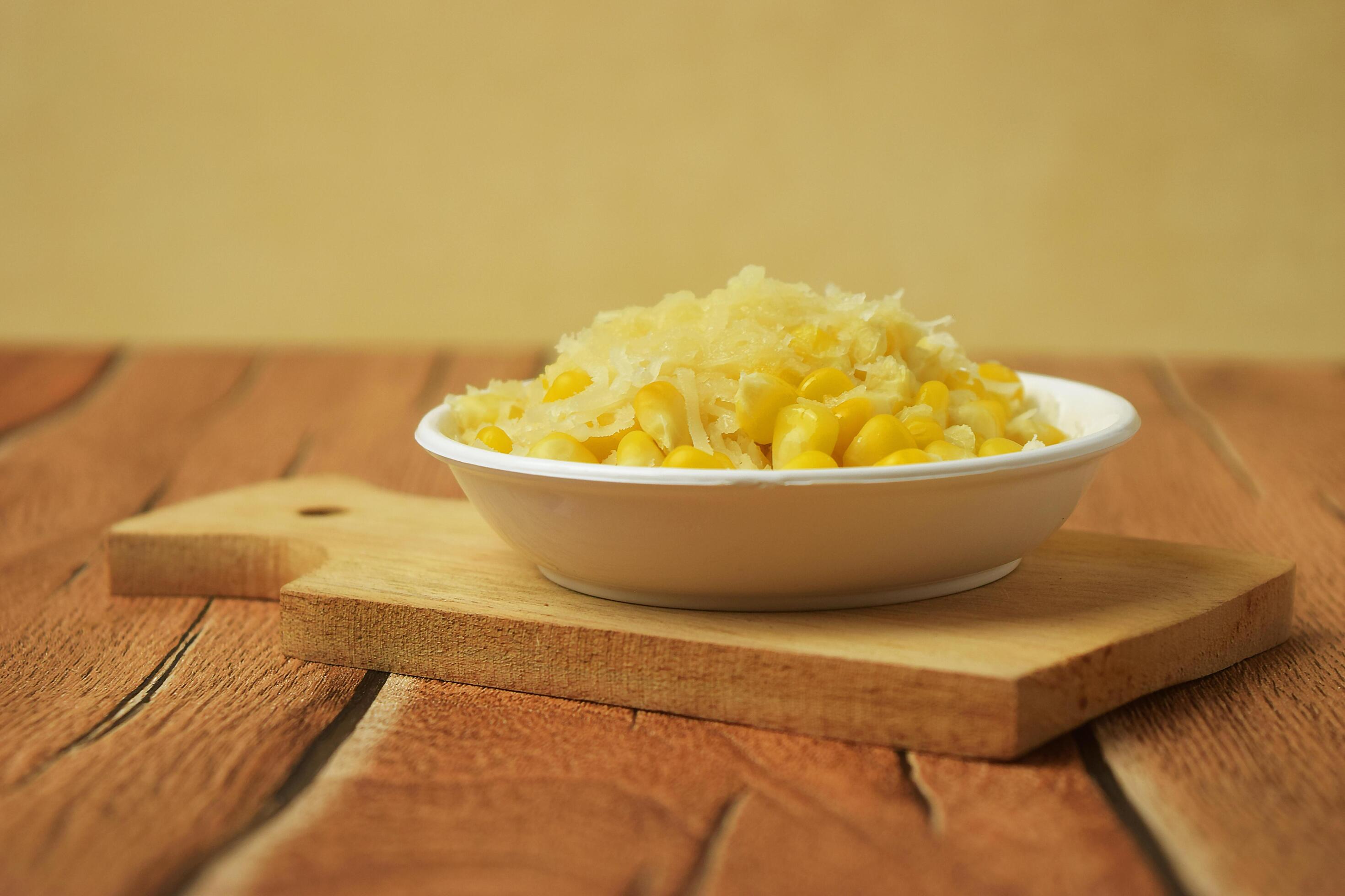 Closeup photo of some shaved corn sprinkled with sweet cheese Stock Free