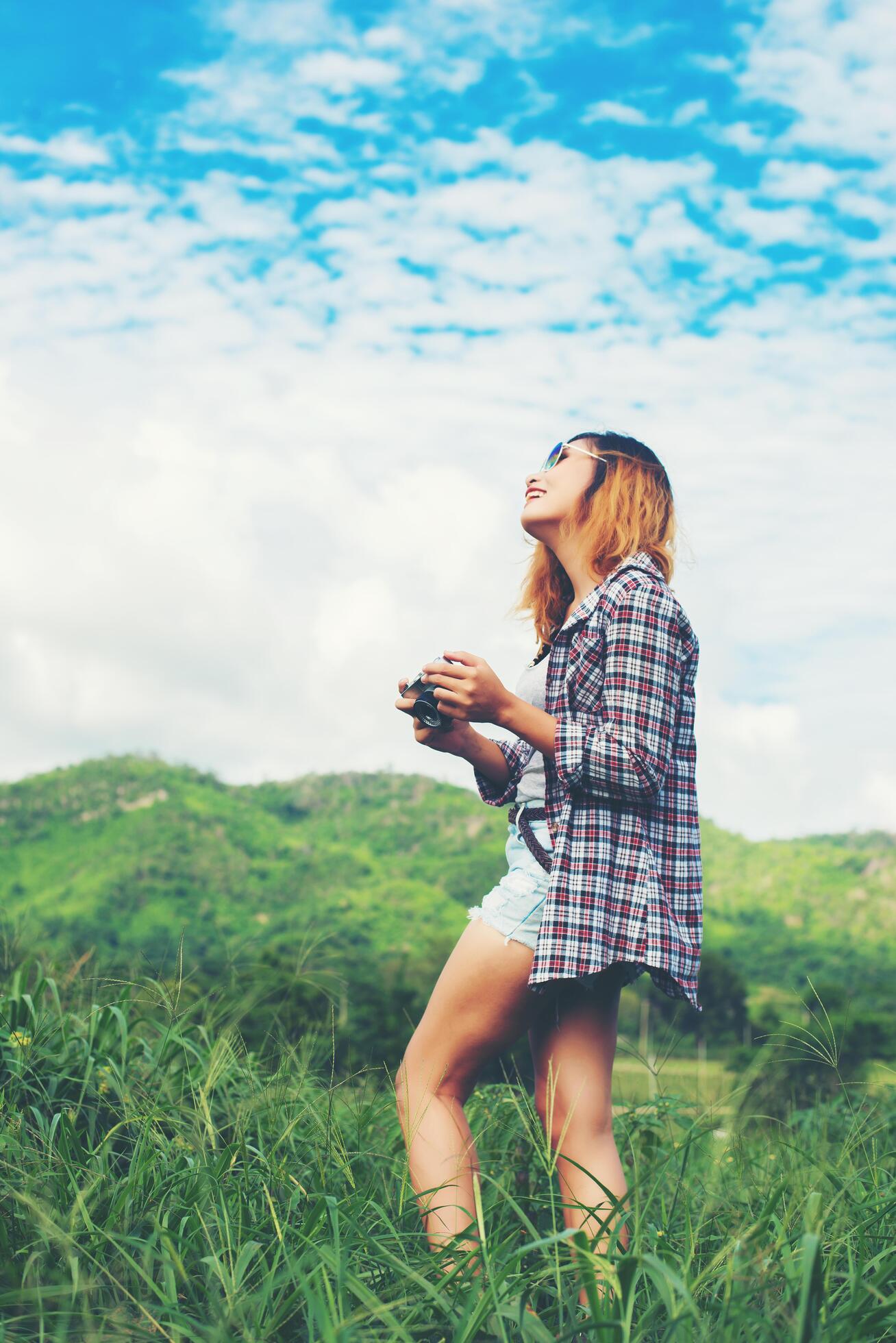 Young Hipster Woman with retro camera taking shot outdoor landscape ,Lifestyle mountain nature on background. Stock Free