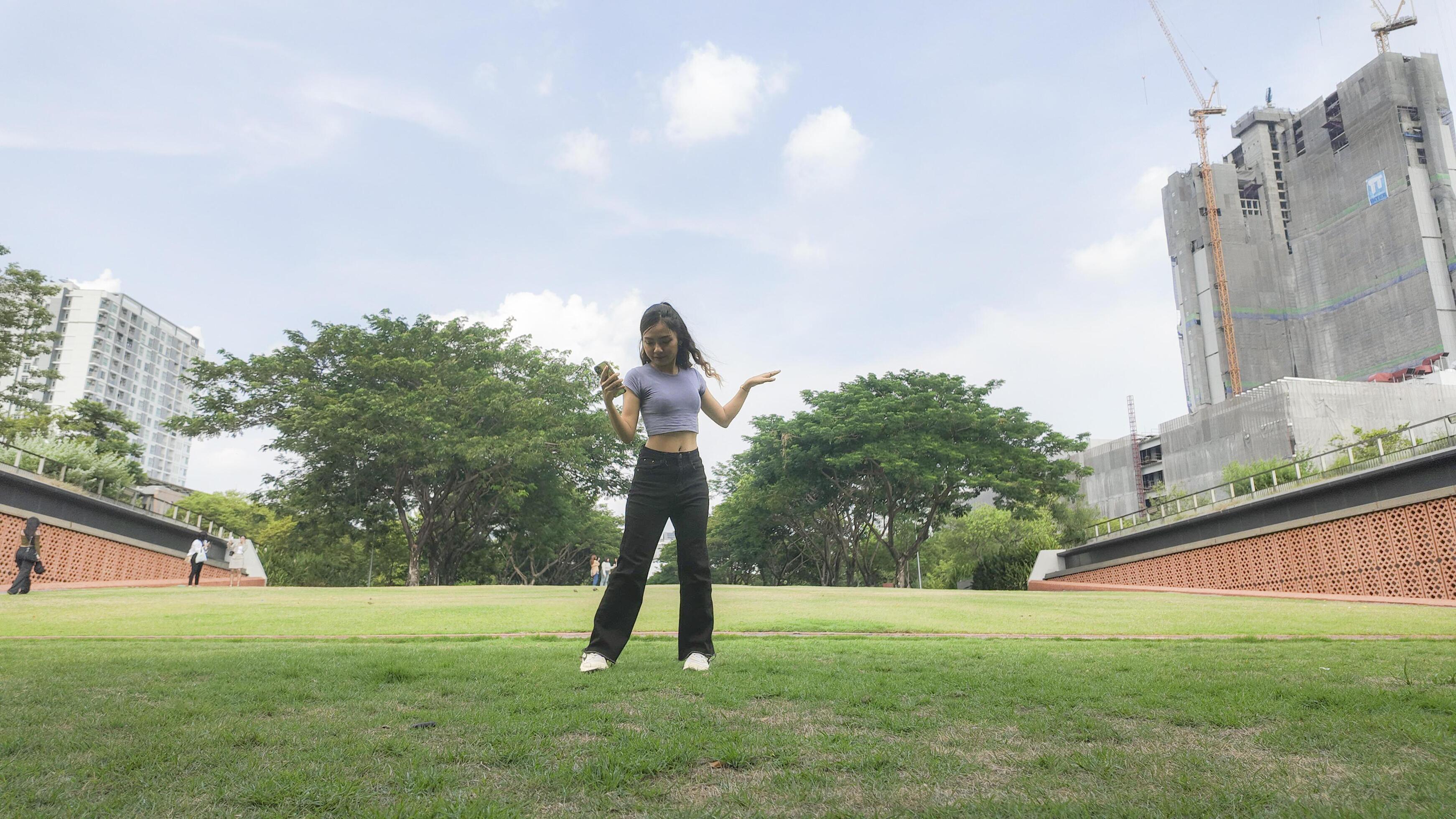 Asian women do freestyle hip hop and breakdancing in a public space in the middle of the city. With a cheerful and happy attitude Stock Free