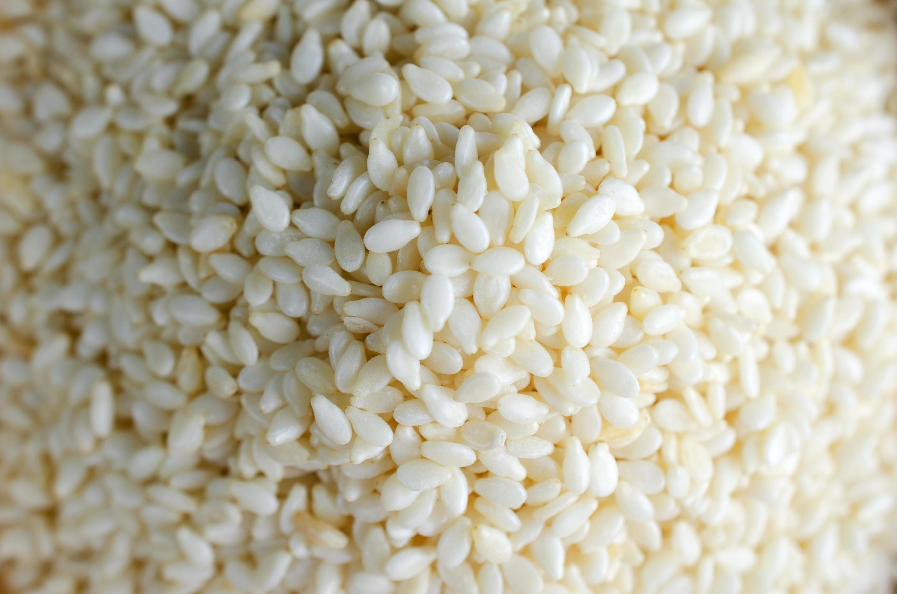 White sesame seeds with macro close up for raw food backgrounds Stock Free