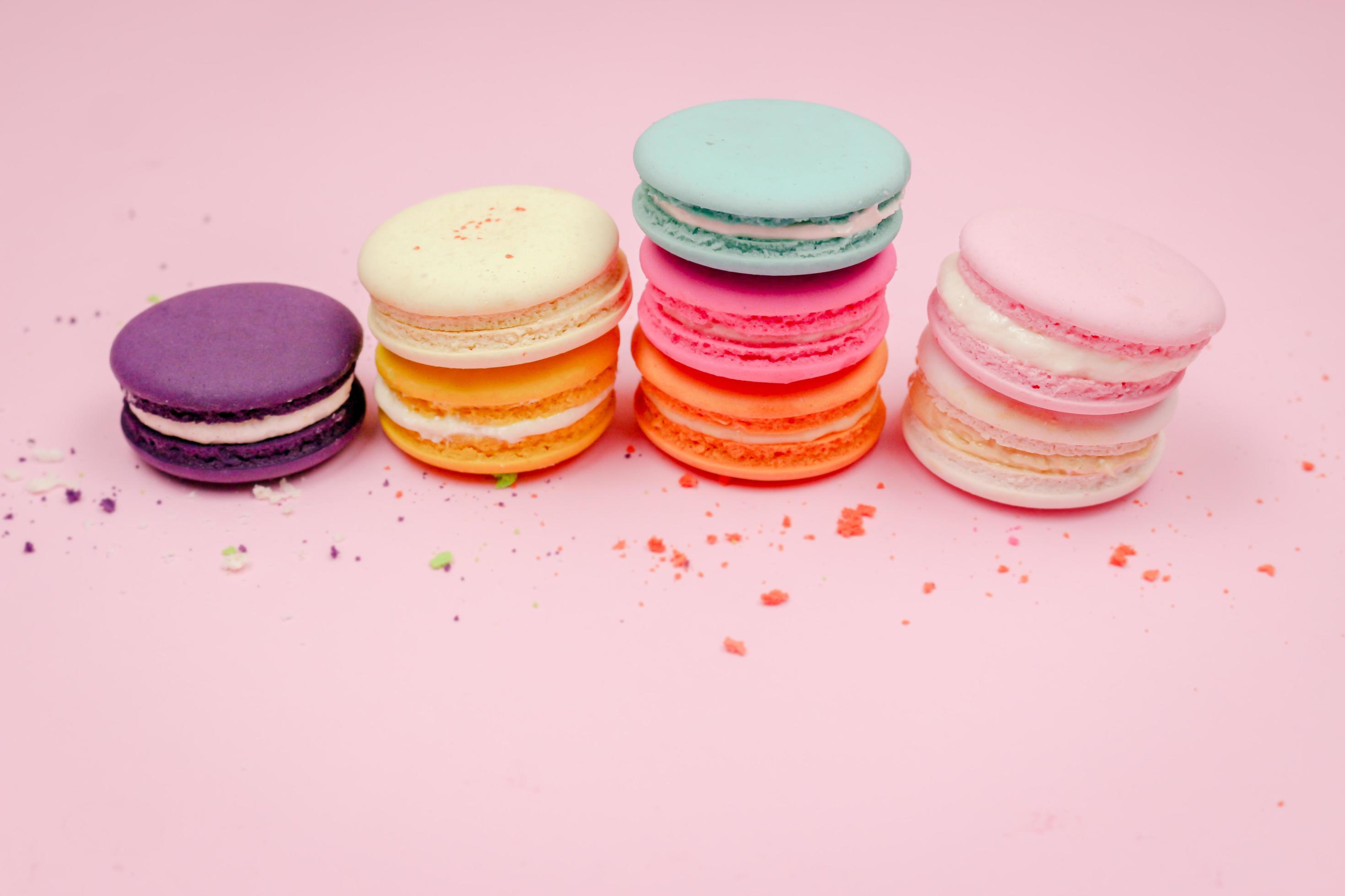 Colorful french macarons macaroons cake, delicious sweet dessert on a pink background with copyspace, food background concept. Stock Free