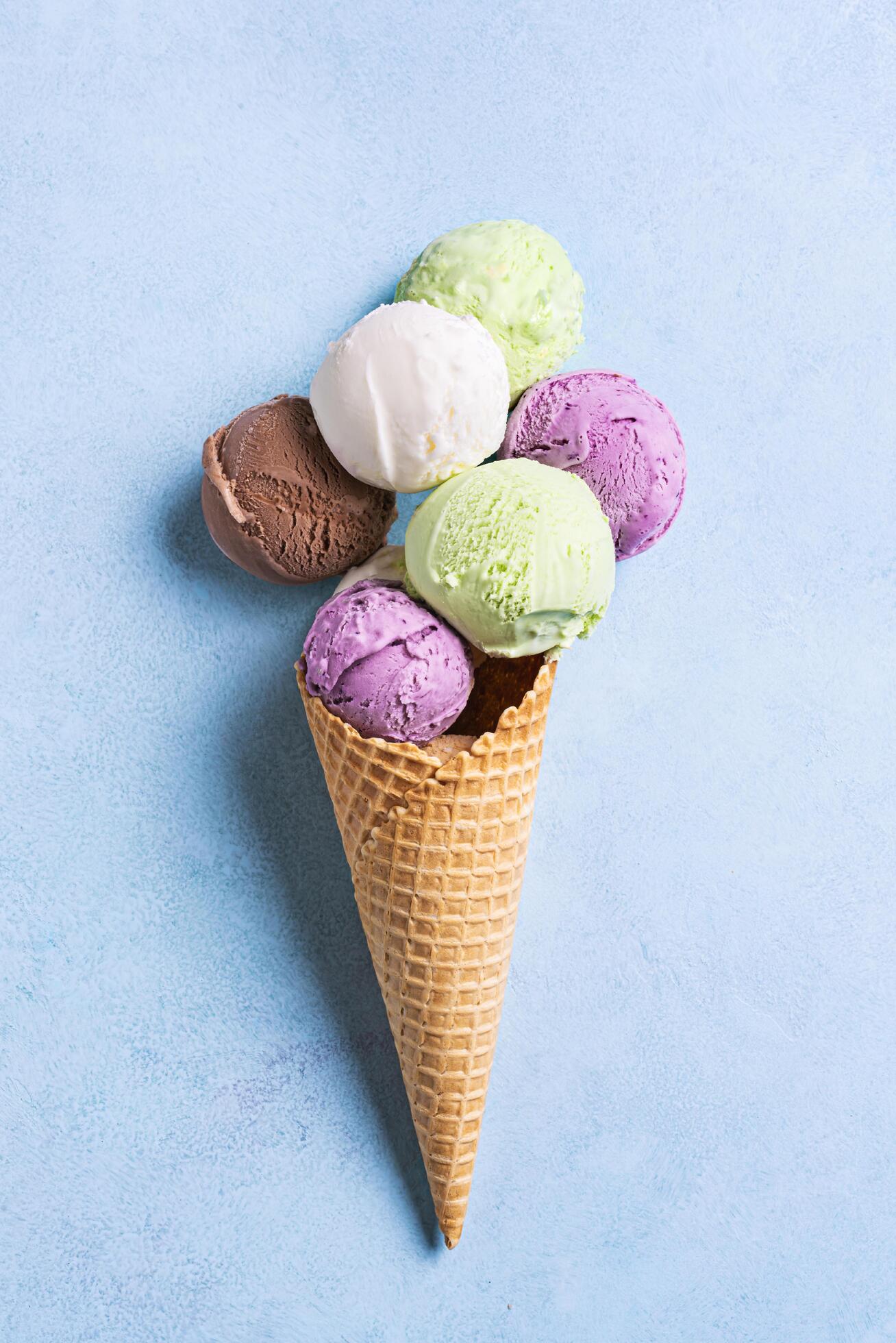 Ice Cream Scoops in Cone on blue background Stock Free