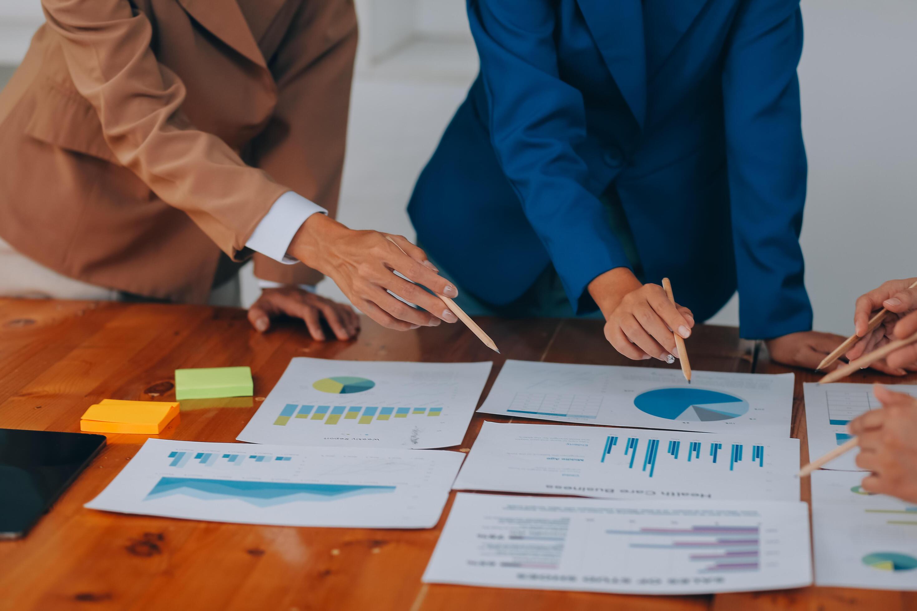 Business professionals. Group of young confident business people analyzing data using computer while spending time in the office Stock Free