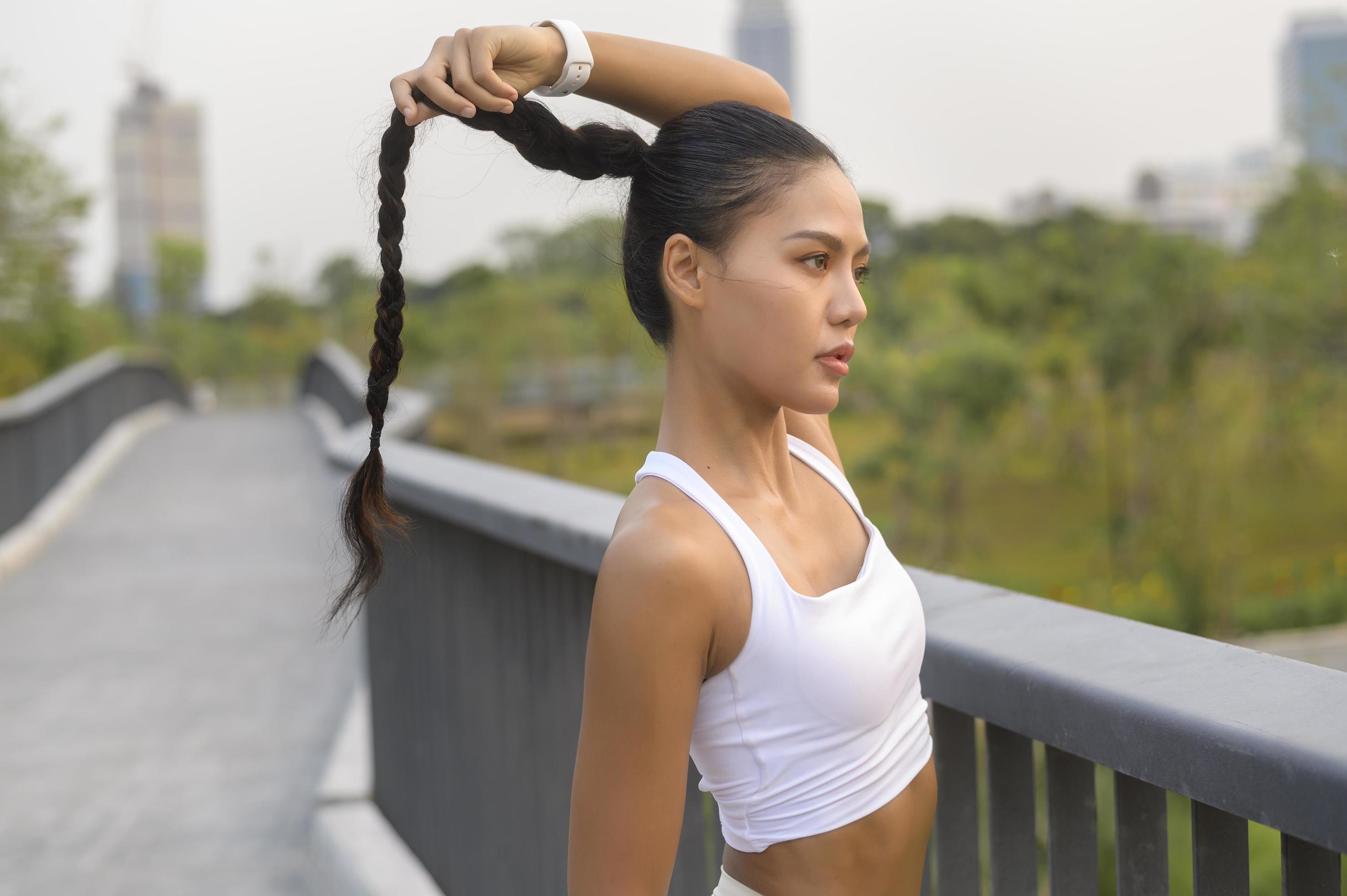 Portrait of young fitness woman in sportswear in city park, Healthy and Lifestyles. Stock Free