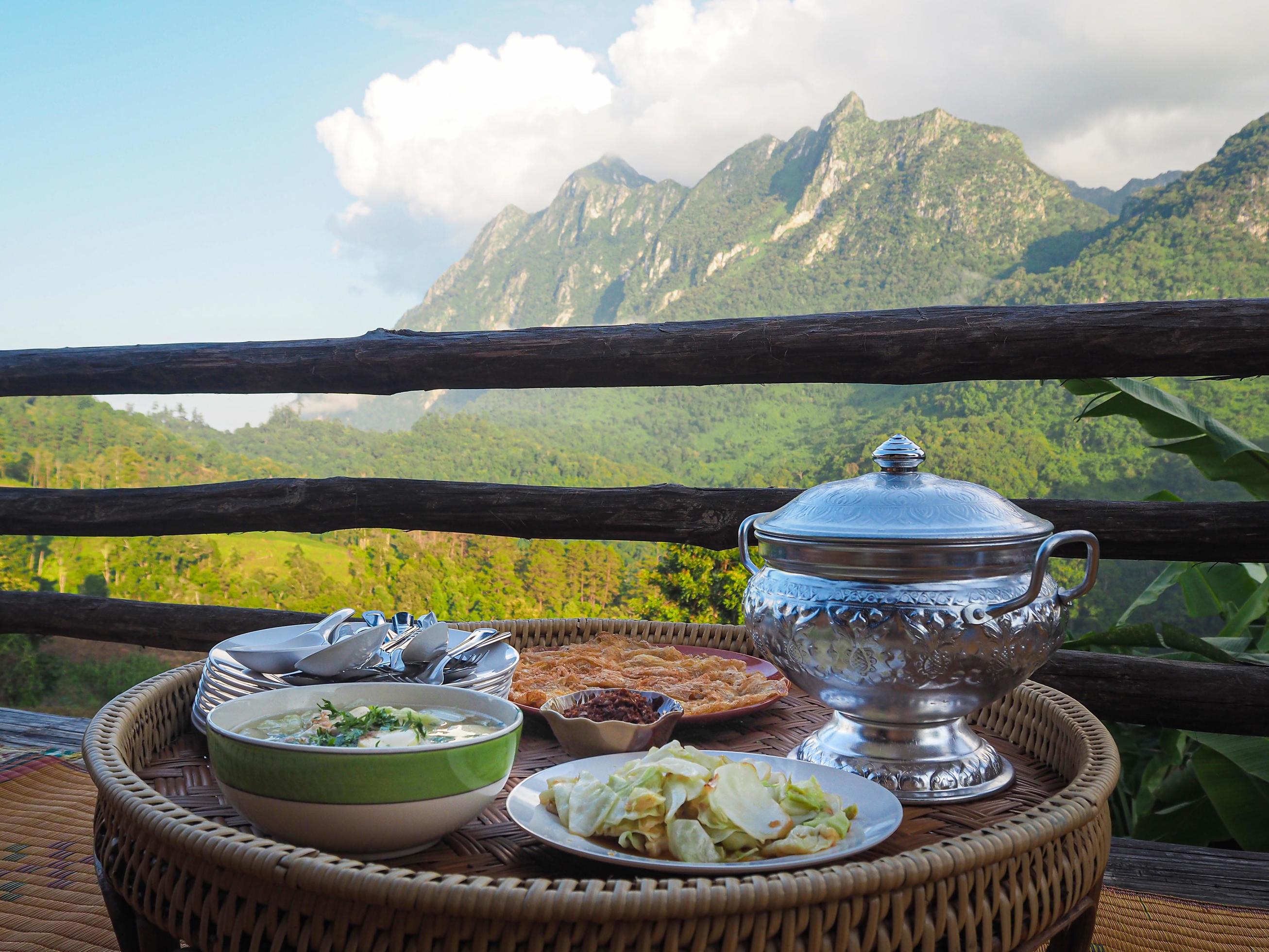 Side view of Thai foods traditionally dinner with mountains background Stock Free