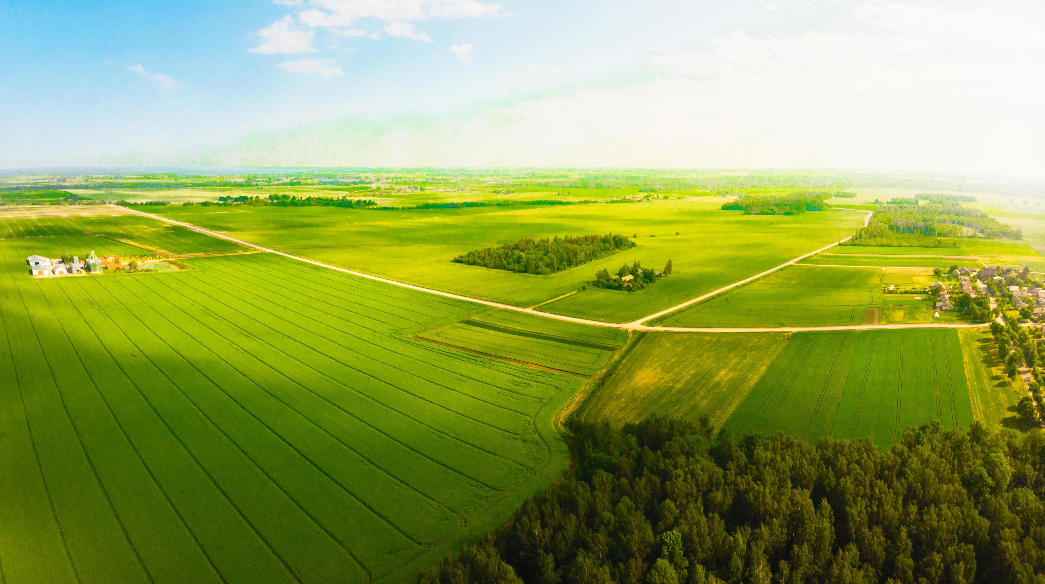 Aerial fly over scenic scenic agricultural farming fields in countryside Lithuania. Stock Free