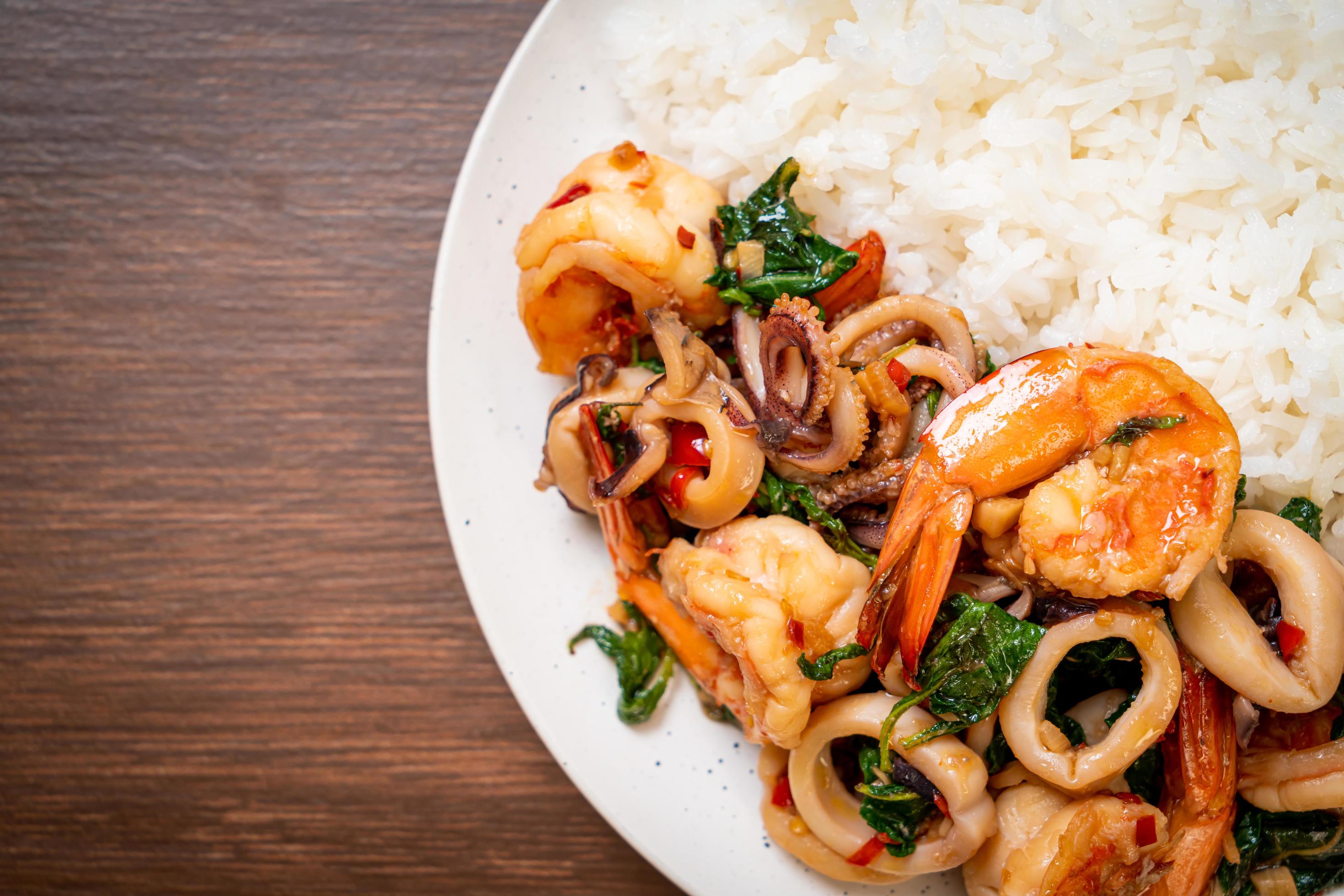 Rice and stir-fried seafood of shrimp and squid with Thai basil – Asian food style Stock Free