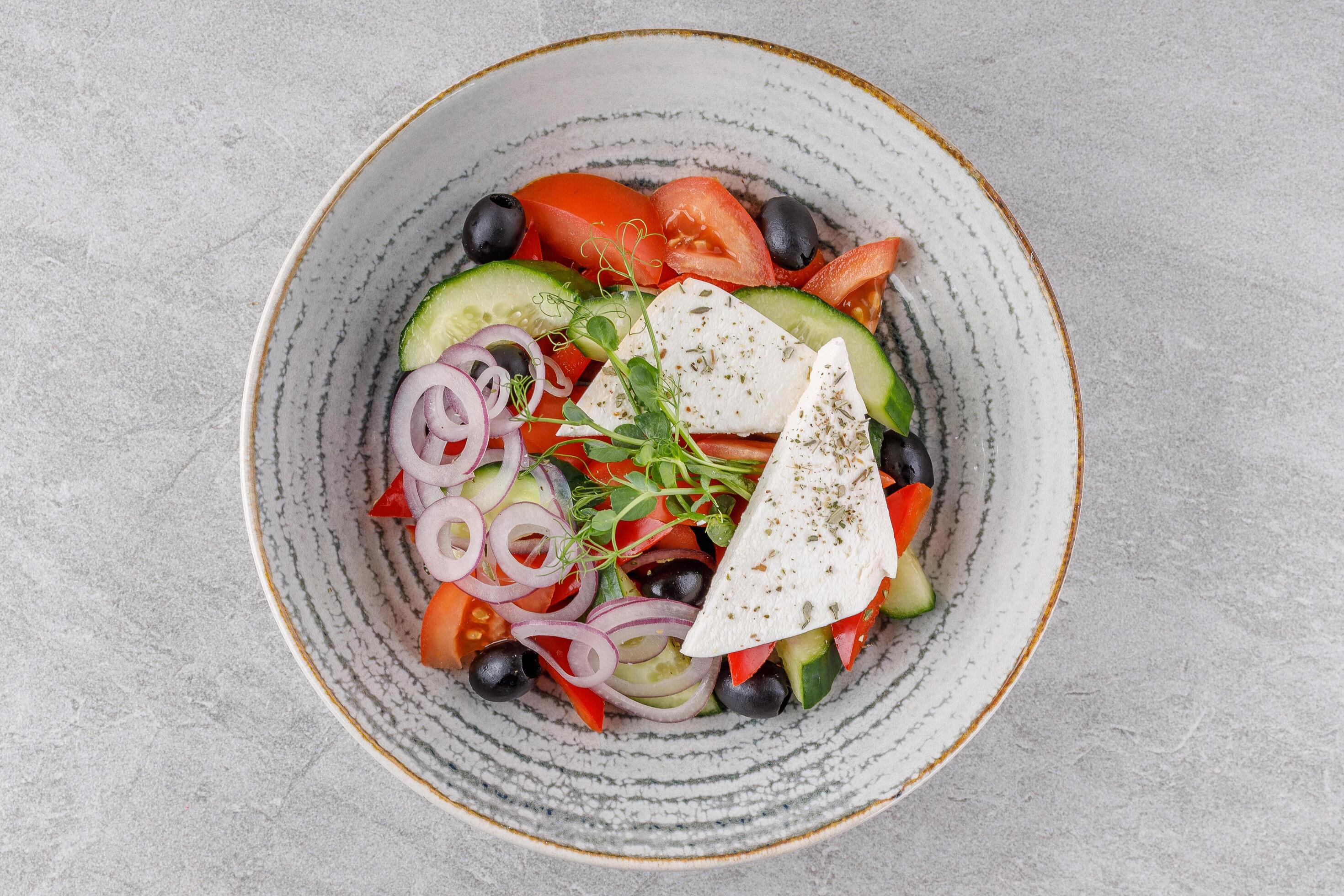 Greek salad on a stone background studio food photo 7 Stock Free