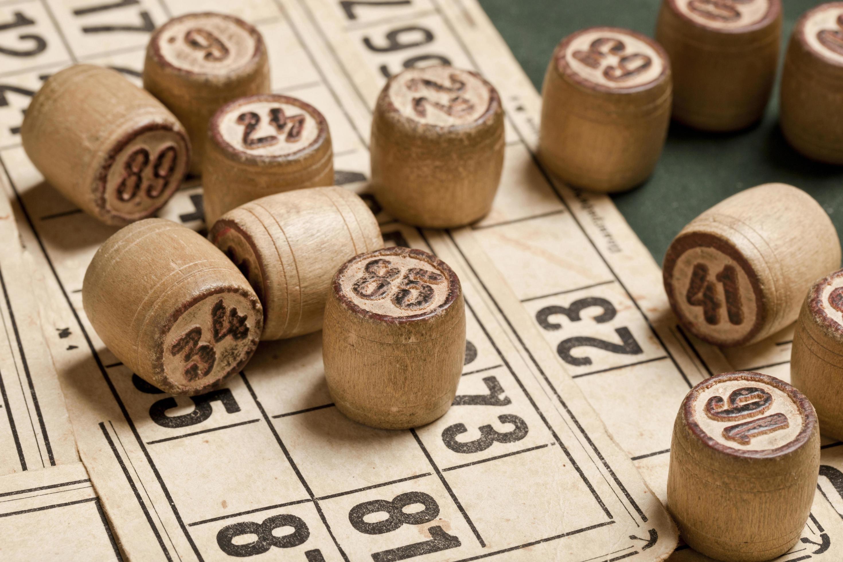 Table game Bingo. Wooden Lotto barrels with bag, playing cards for Lotto games, games for family. Stock Free