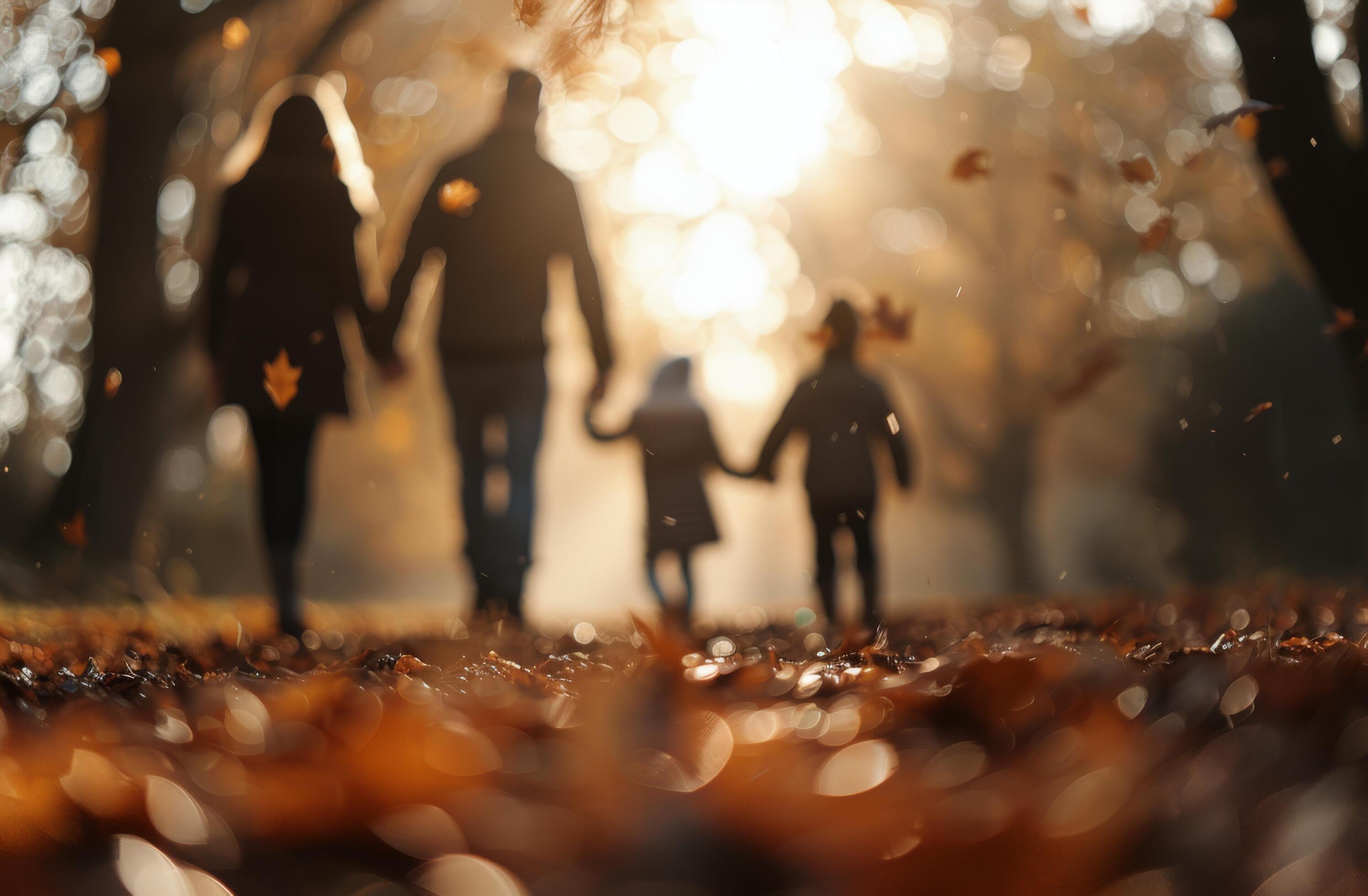 Family Walk During Autumn Sunset in a Leaf-Covered Trail Stock Free