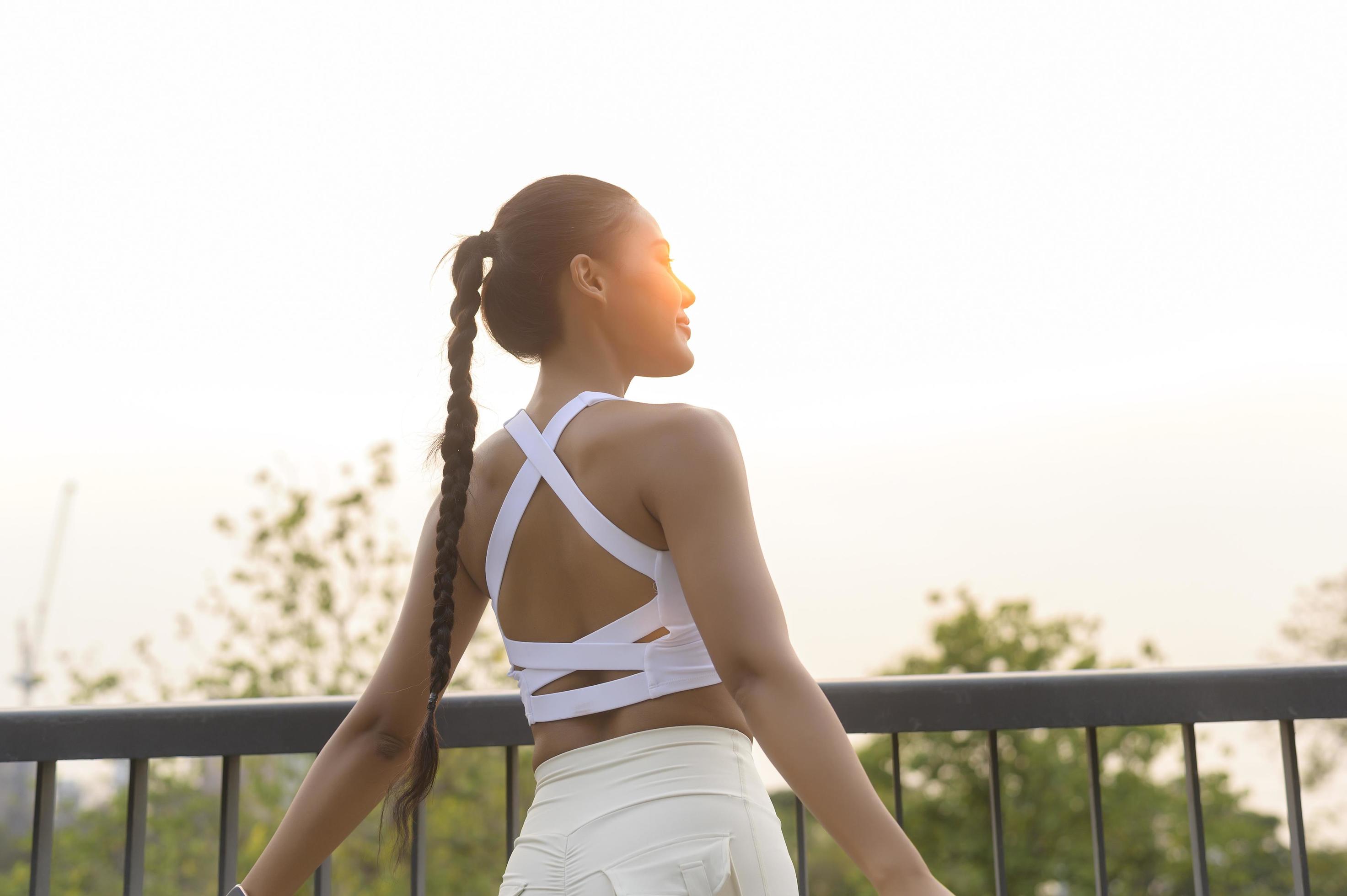 Portrait of young fitness woman in sportswear in city park, Healthy and Lifestyles. Stock Free