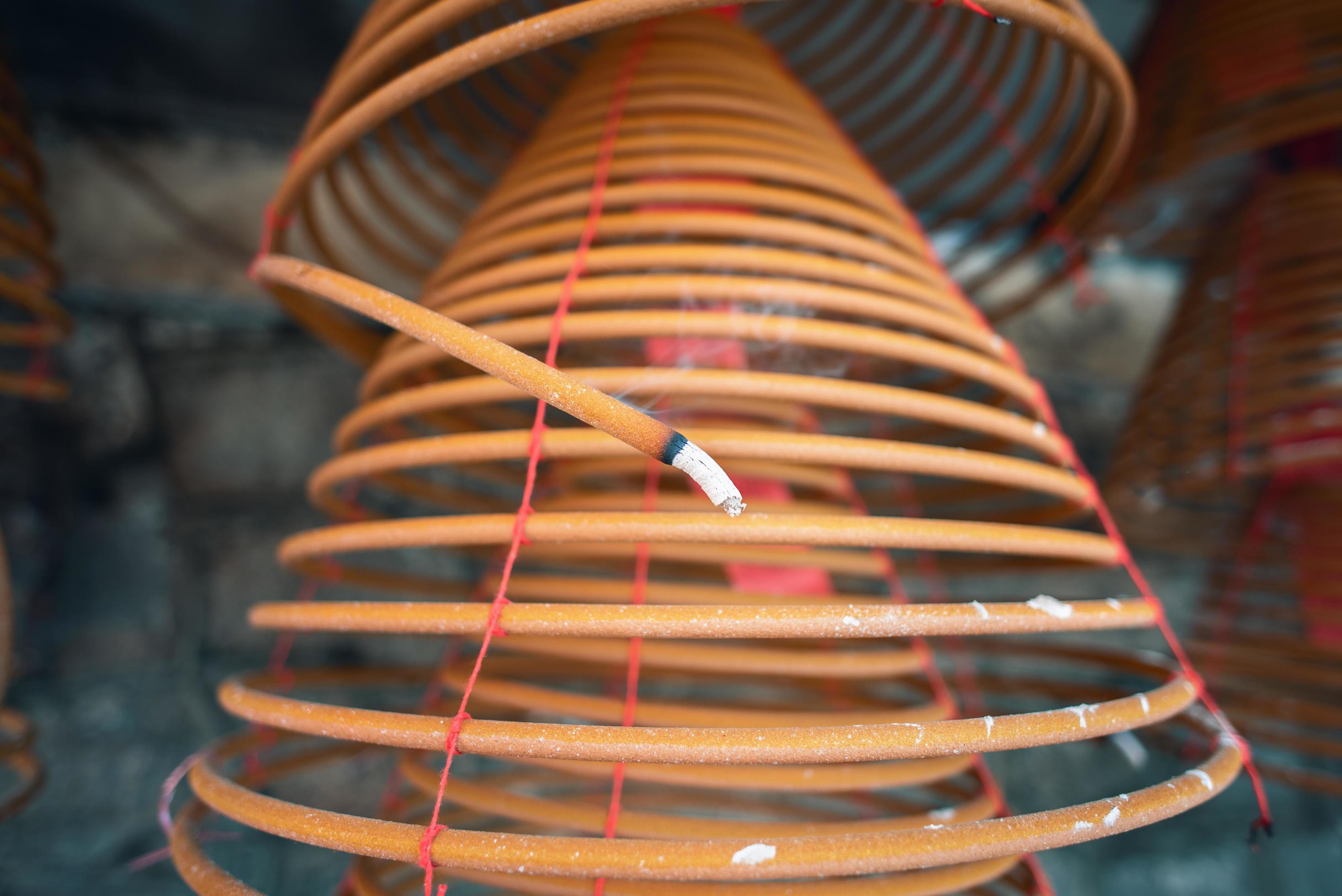 Burned coil swirl incense in Macau Macao temple, traditional Chinese cultural customs to worship god, close up, lifestyle. Stock Free