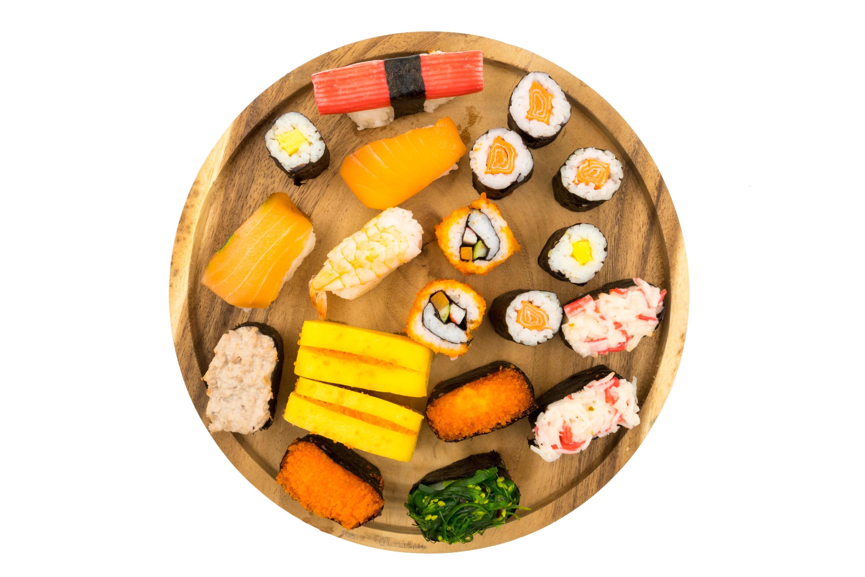 Top view of Sushi set on wooden plate on white background, Japanese food. Stock Free