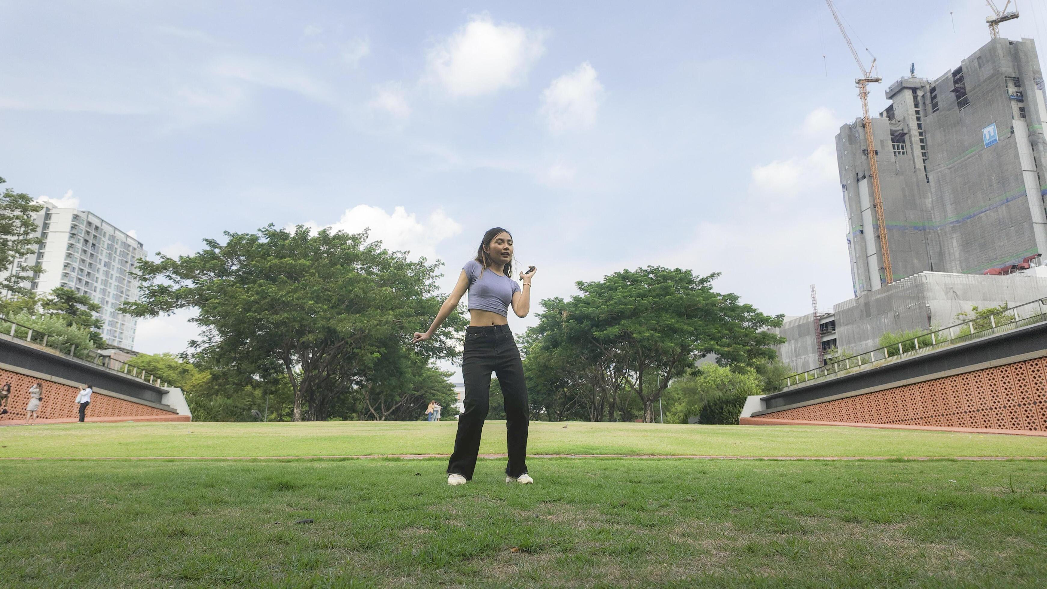 Asian women do freestyle hip hop and breakdancing in a public space in the middle of the city. With a cheerful and happy attitude Stock Free