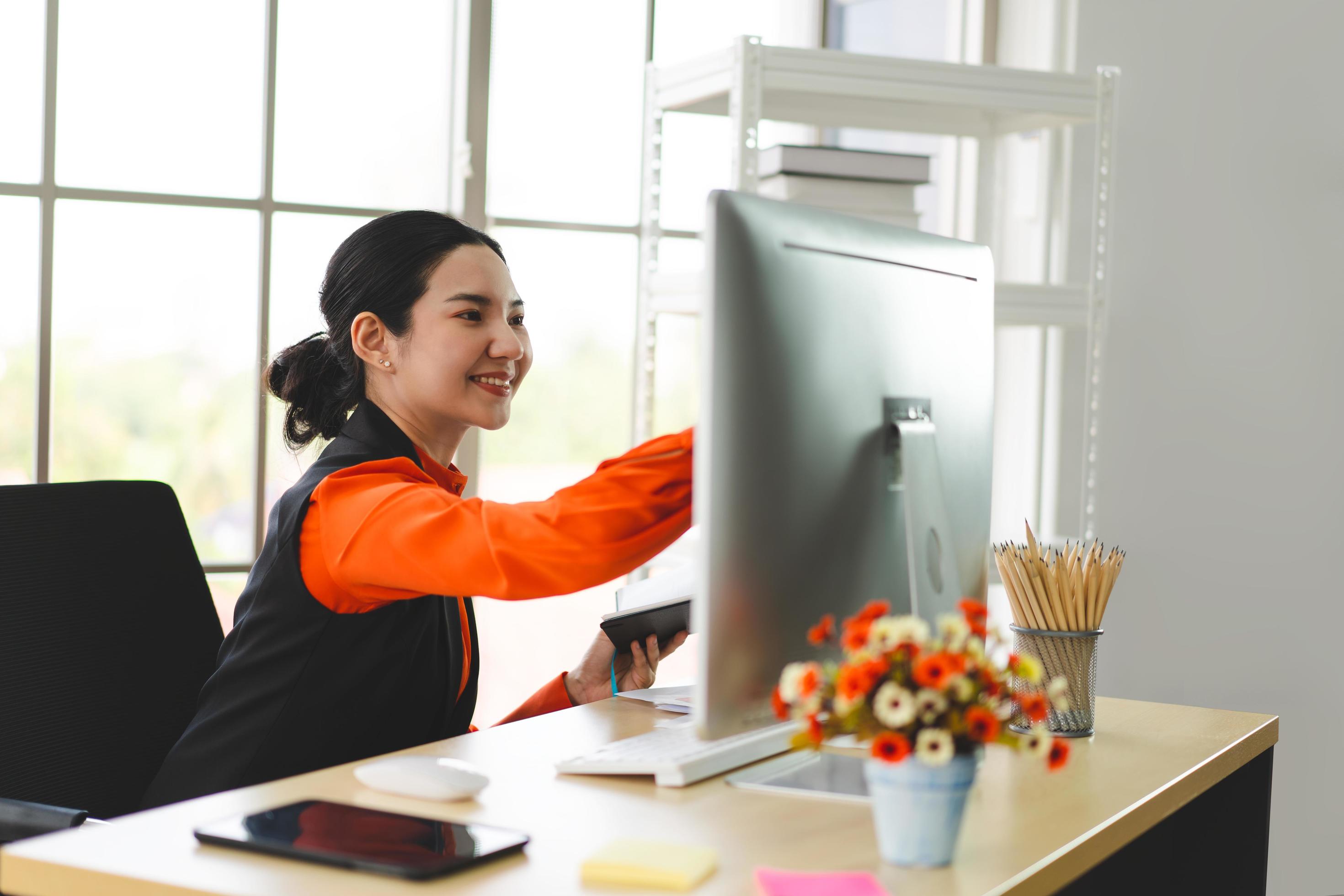 Young adult asian business woman working with computer at office workpalce on day. Stock Free