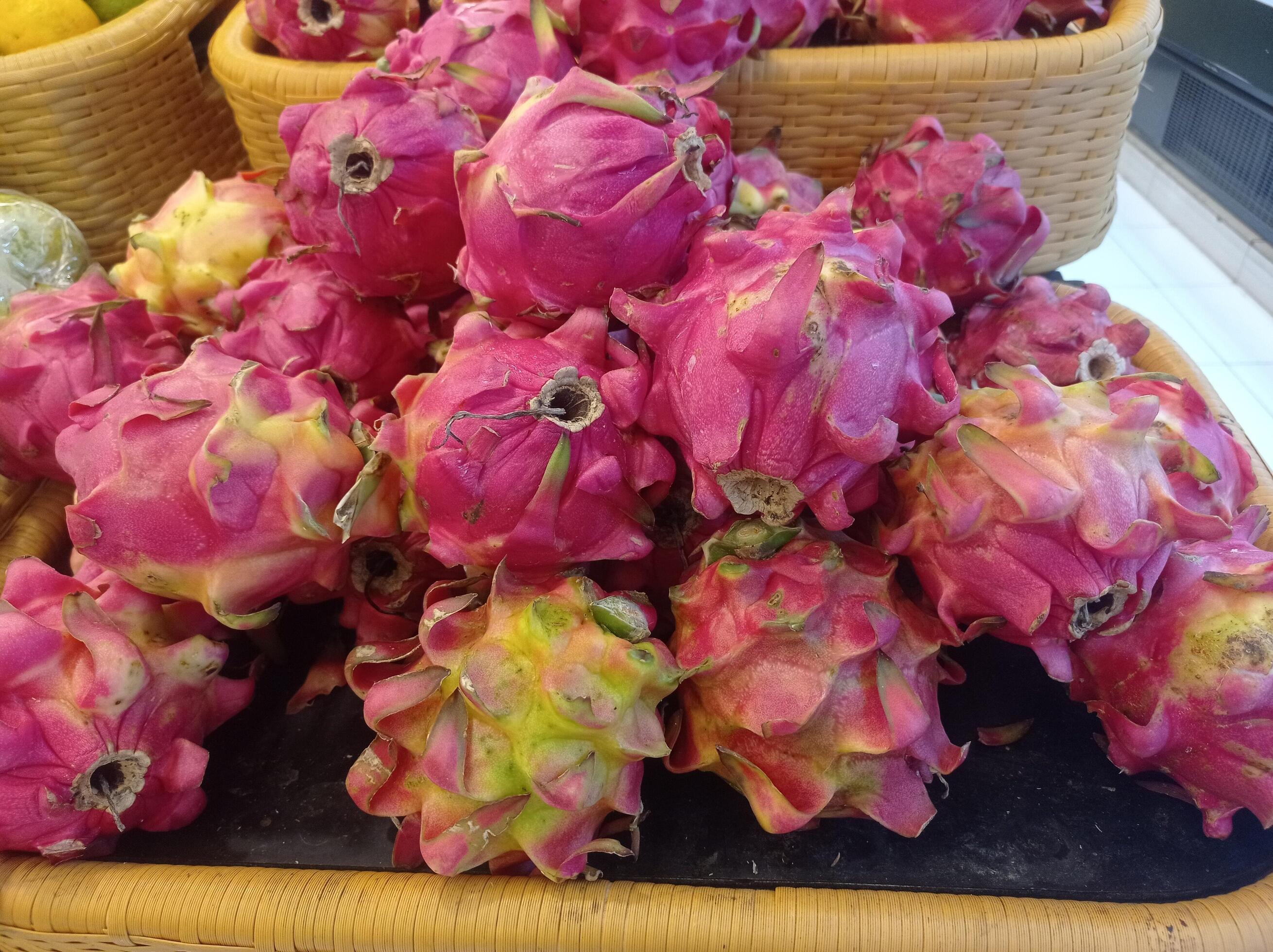 pile of fresh red dragon fruit in a minimarket basket Stock Free