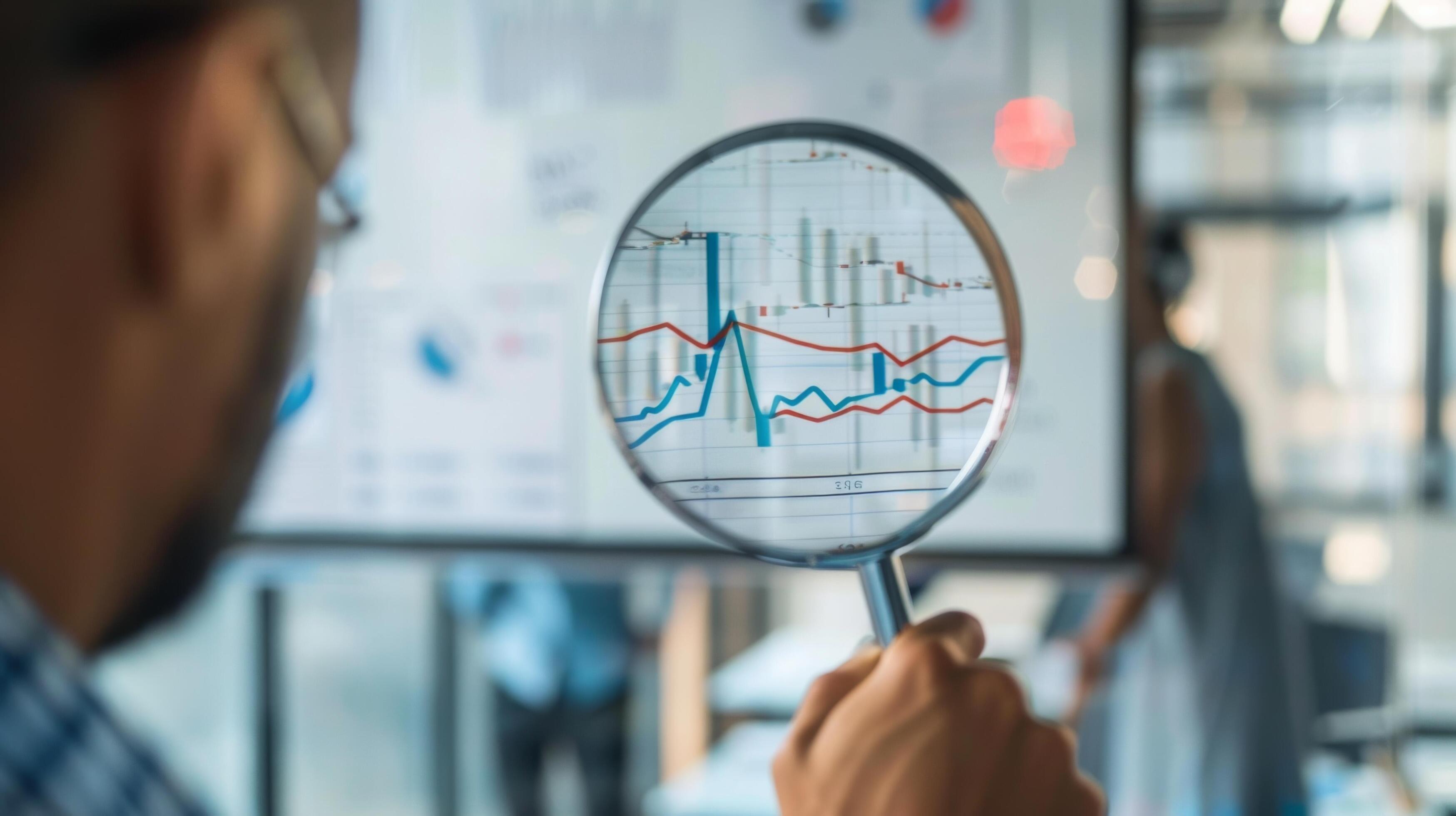 Close-Up of Magnifying Glass Focused on Stock Market Indicators with Blurred Background Stock Free