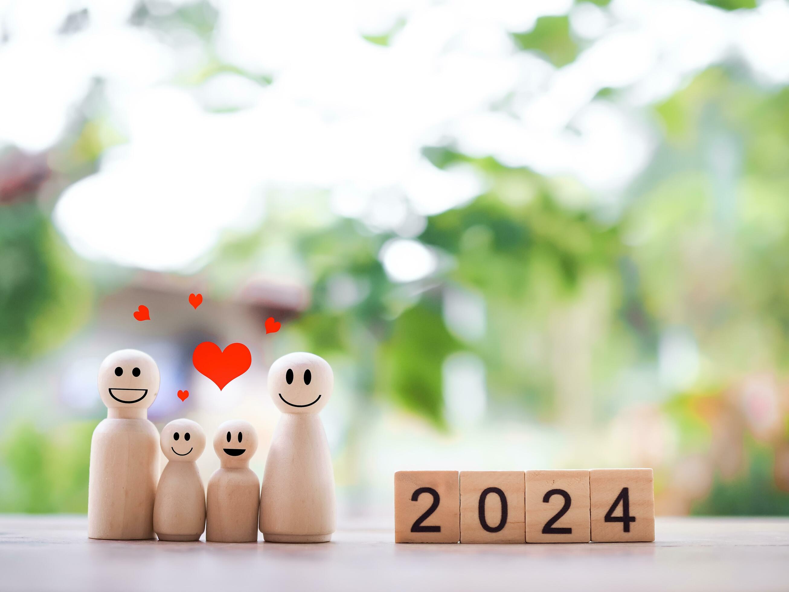 Wooden figure family happy face with heart and wooden block with number 2024. The concept of romantic feelings, family relationship. Stock Free