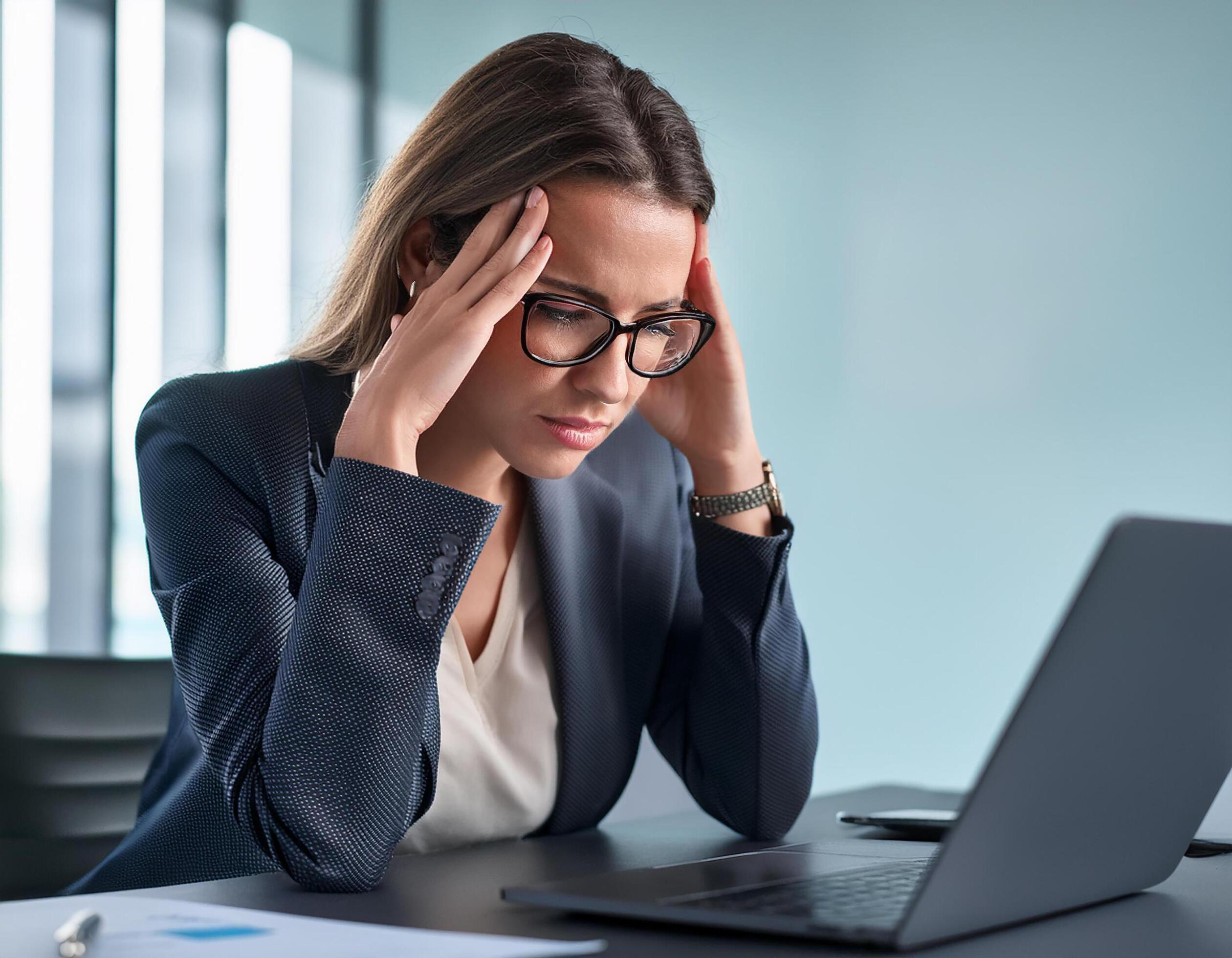 Young caucasian business woman in her 30s in front of laptop looking stressed, upset, worried, at work. Stock Free