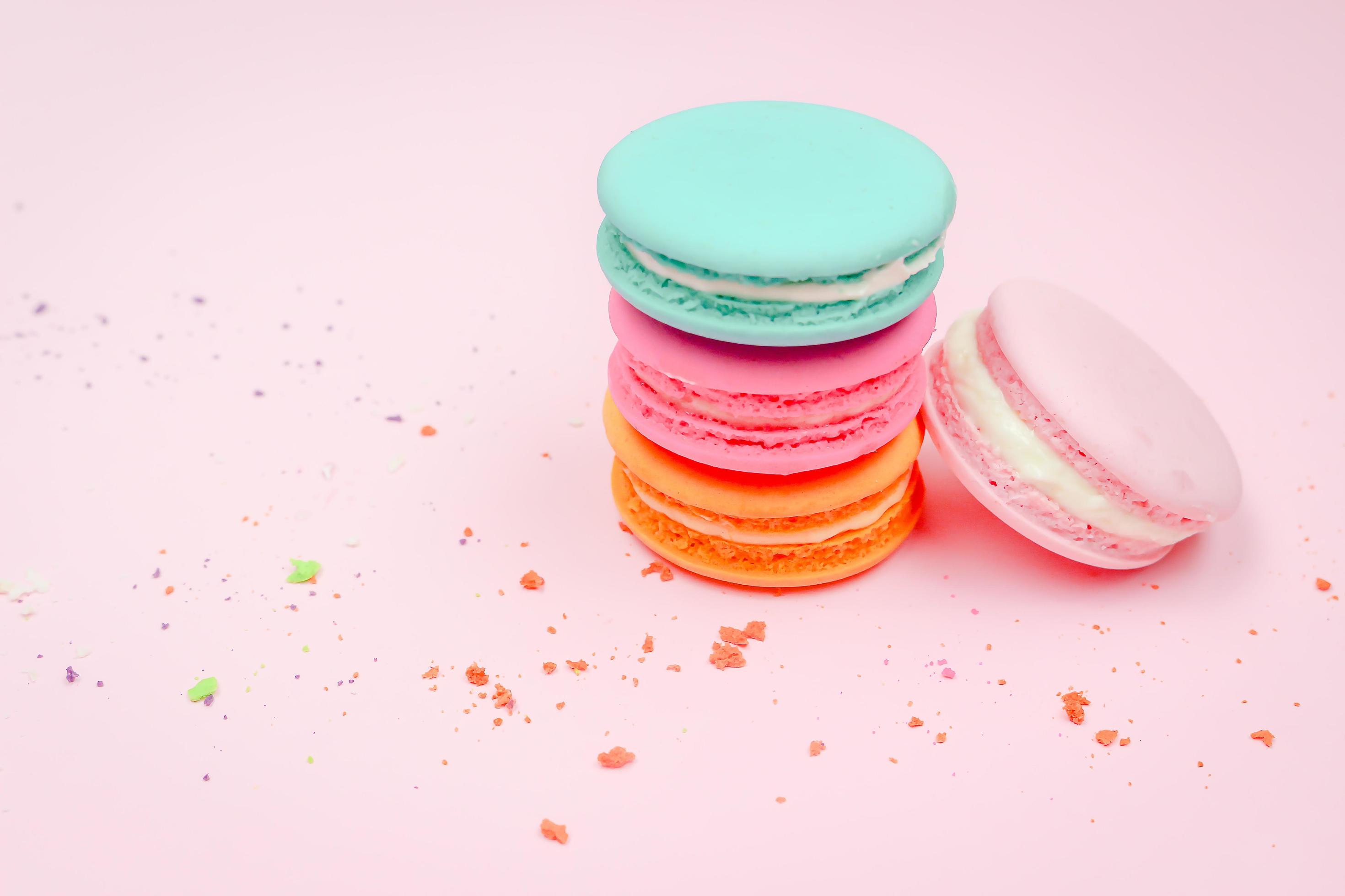 Colorful french macarons macaroons cake, delicious sweet dessert on a pink background with copyspace, food background concept. Stock Free