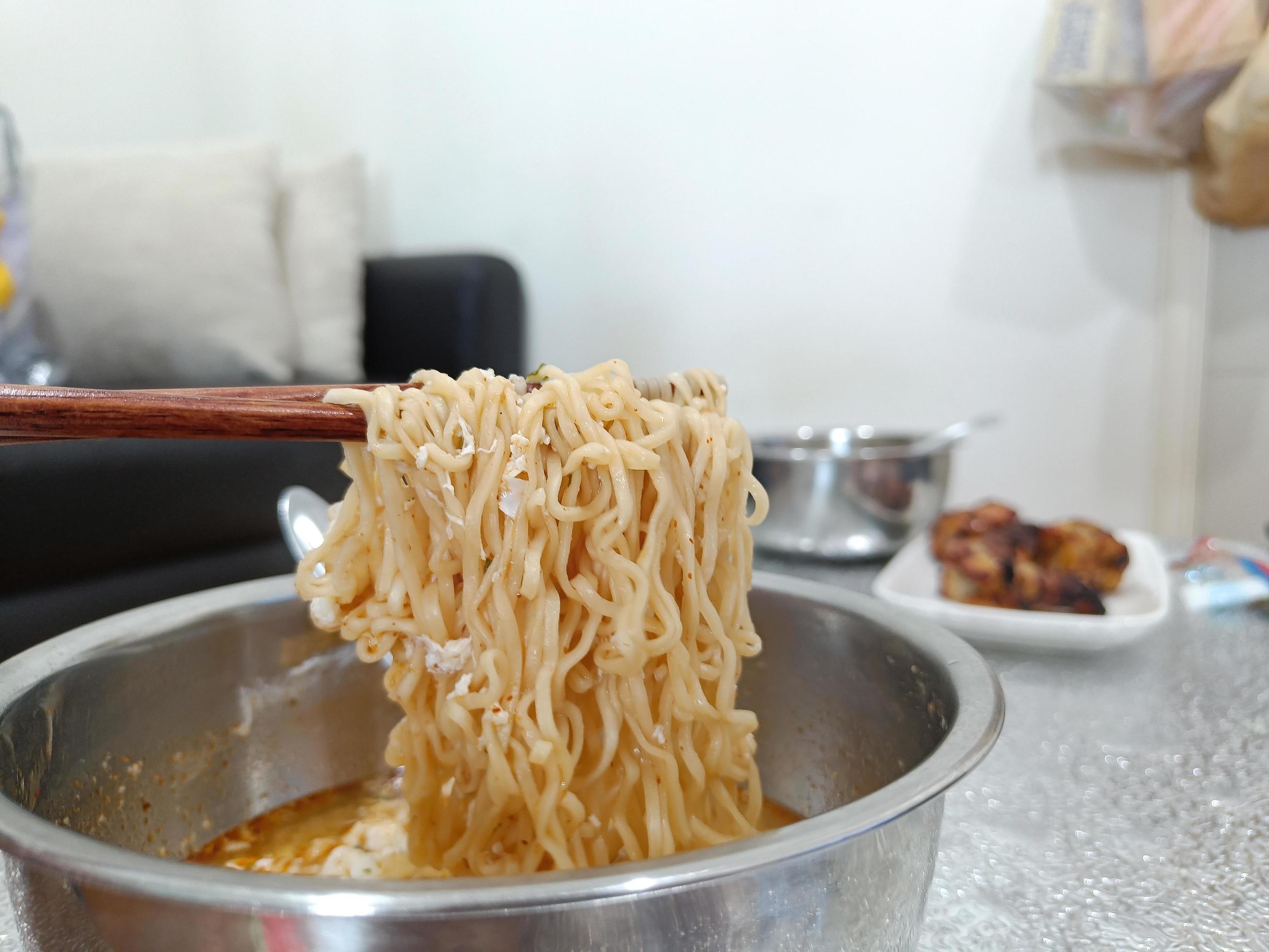 Bowl of instant noodles. Chopsticks. The food of the salaryman who struggles with the expensive cost of living Stock Free