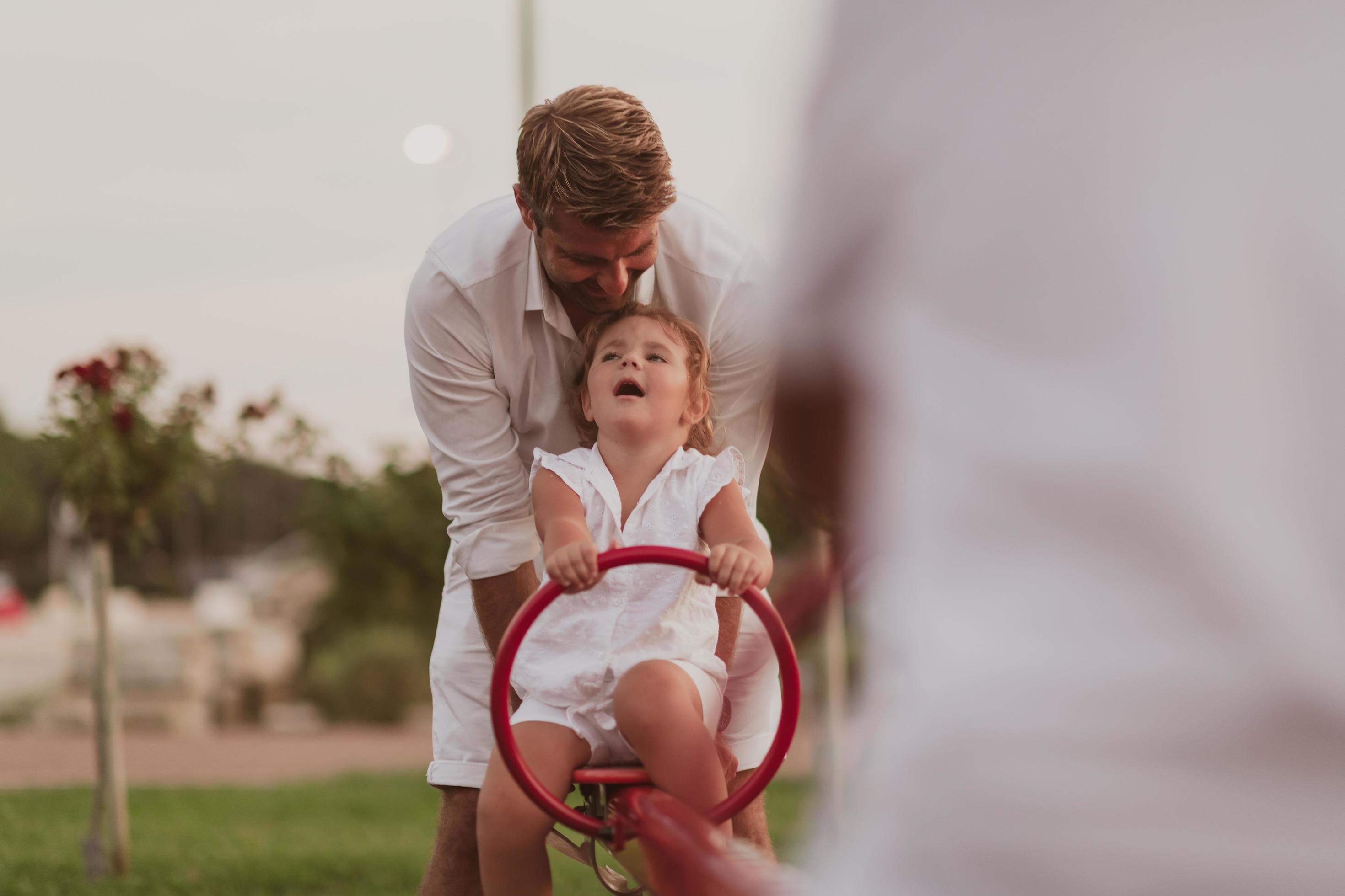 An elderly man in casual clothes with his daughter spends time together in the park on vacation. Family time. Selective focus Stock Free