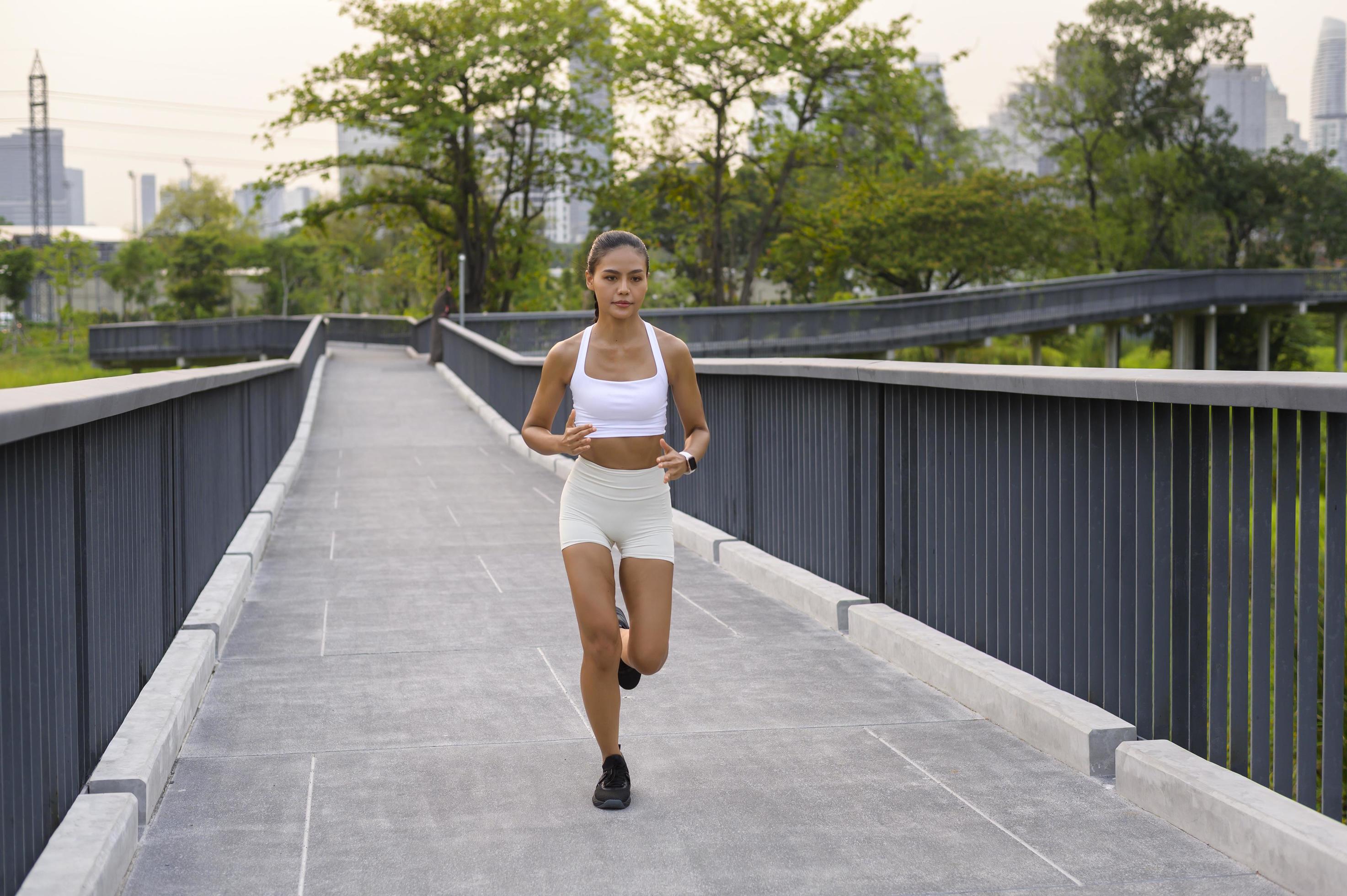 Young fitness woman in sportswear jogging in city park, Healthy and Lifestyles. Stock Free