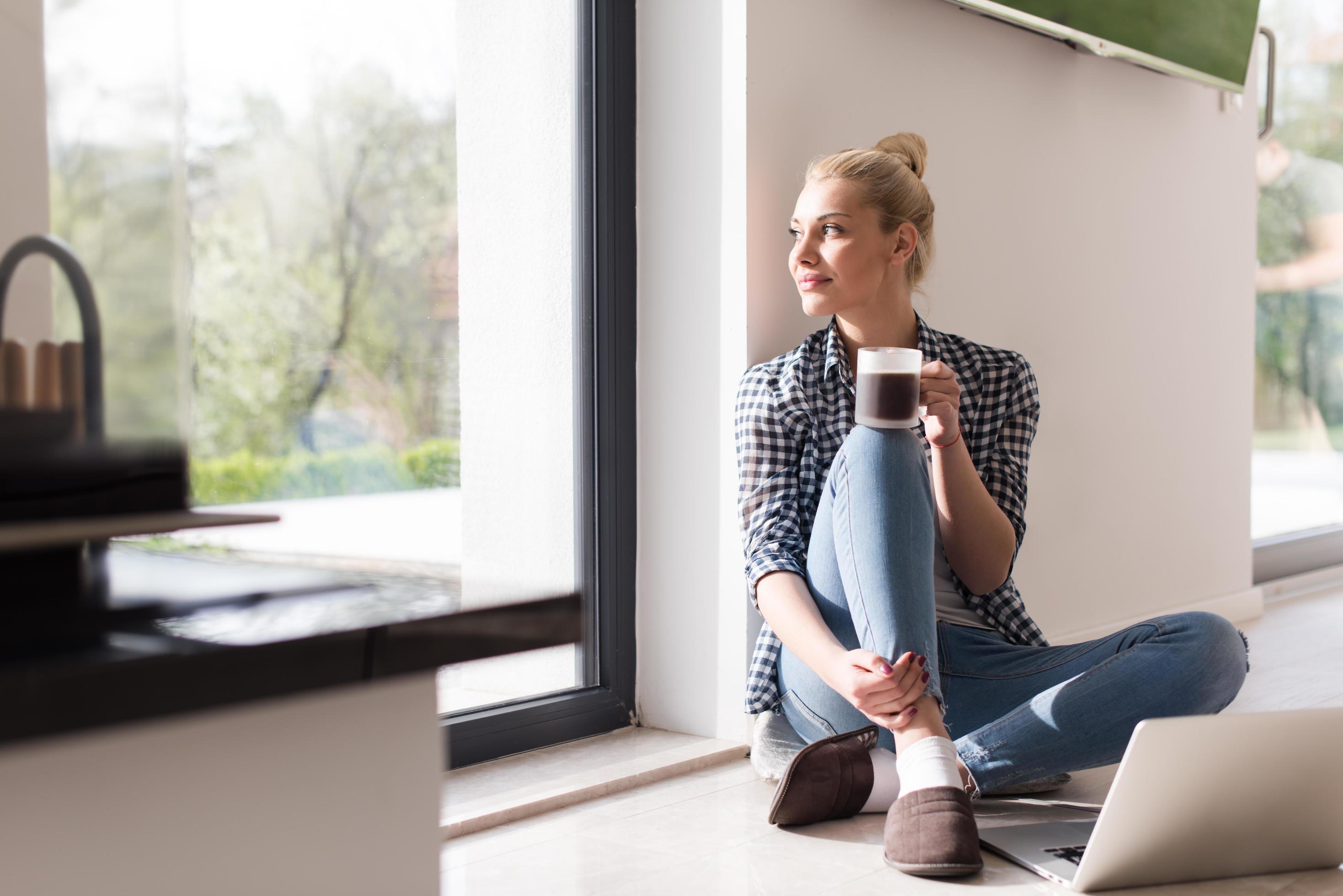 young woman drinking coffee enjoying relaxing lifestyle Stock Free