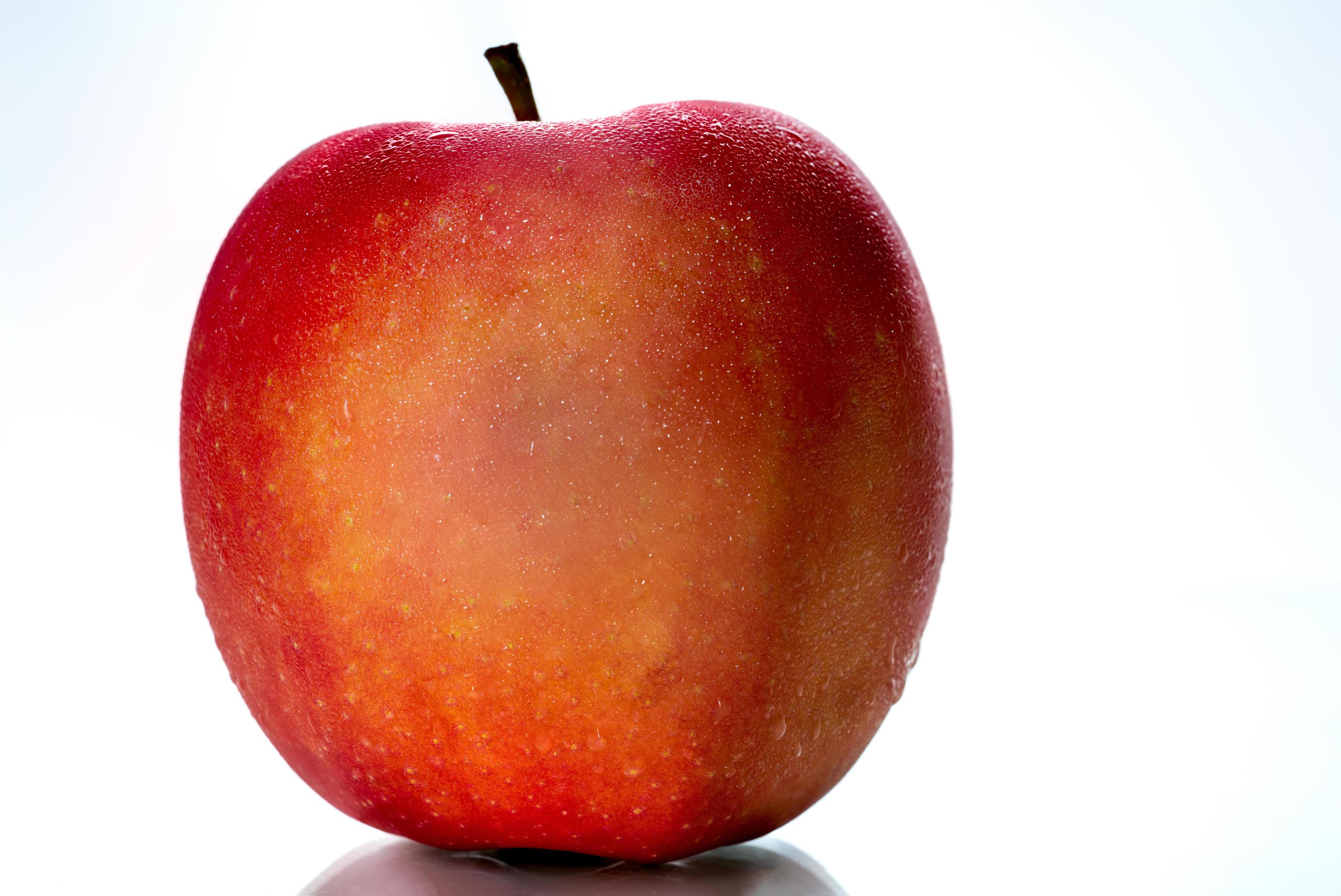 A red apple with water drops on skin isolated on white background with copy space. Healthy fruit and healthy food concept. Vegan food. Stock Free